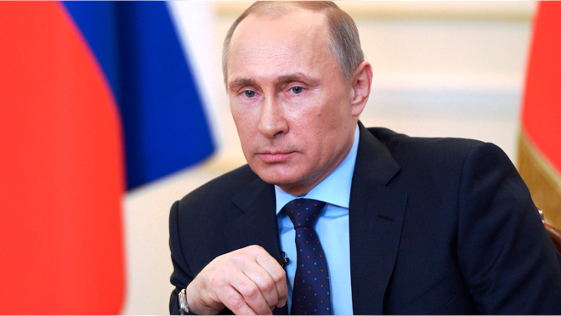 President Vladimir Putin listens journalists' questions on current situation in Ukraine at the Novo-Ogaryovo presidential residence outside Moscow on Tuesday, March 4, 2014.