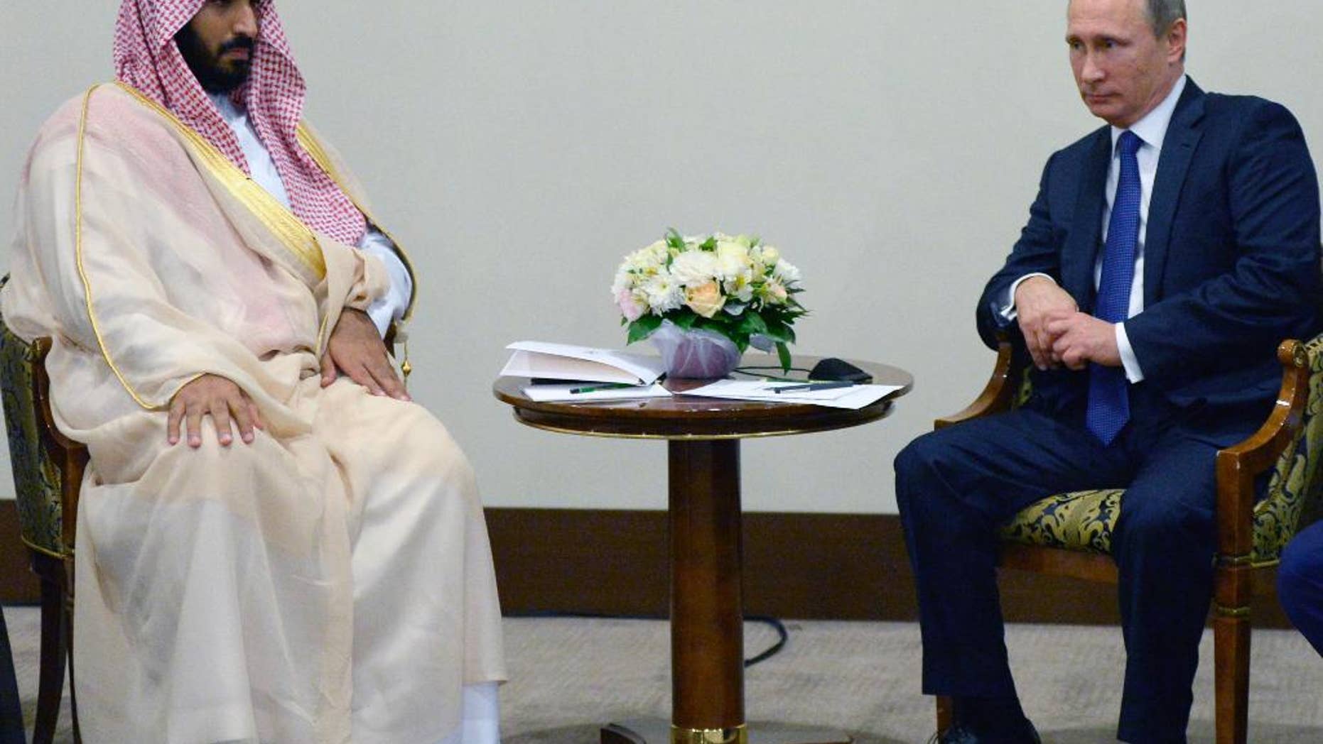 Russian President Vladimir Putin, right, and Saudi's Second Deputy Prime Minister and Minister of Defense and Deputy Crown Prince Mohammed bin Salman bin Abdulaziz Al Saud pose for the media after the Formula One Russian Grand Prix at the Sochi Autodrom, in Sochi, Russia, Sunday, Oct. 11, 2015. (Alexei Nikolsky, RIA-Novosti, Kremlin Pool Photo via AP)