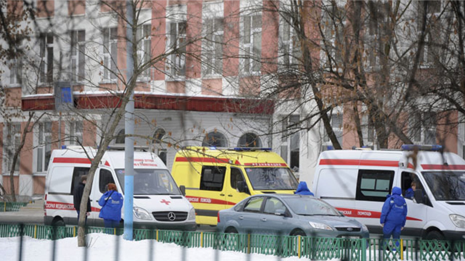 February 3, 2014: Ambulances are parked at an entrance to a school in Moscow, Russia. Moscow police said an armed teenager burst into the school and killed a security guard and a teacher before being taken into custody. (AP Photo/Anton Belitsky)
