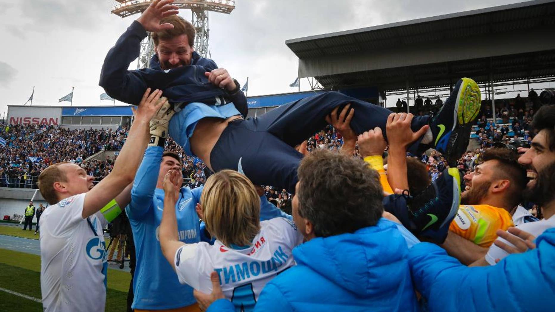 Zenit's players throw Zenit’s head coach Andre Villas-Boas as they celebrate after winning the national soccer Championship after match against Ufa in St.Petersburg, Russia, Sunday, May 17, 2015. (AP Photo/Dmitry Lovetsky)