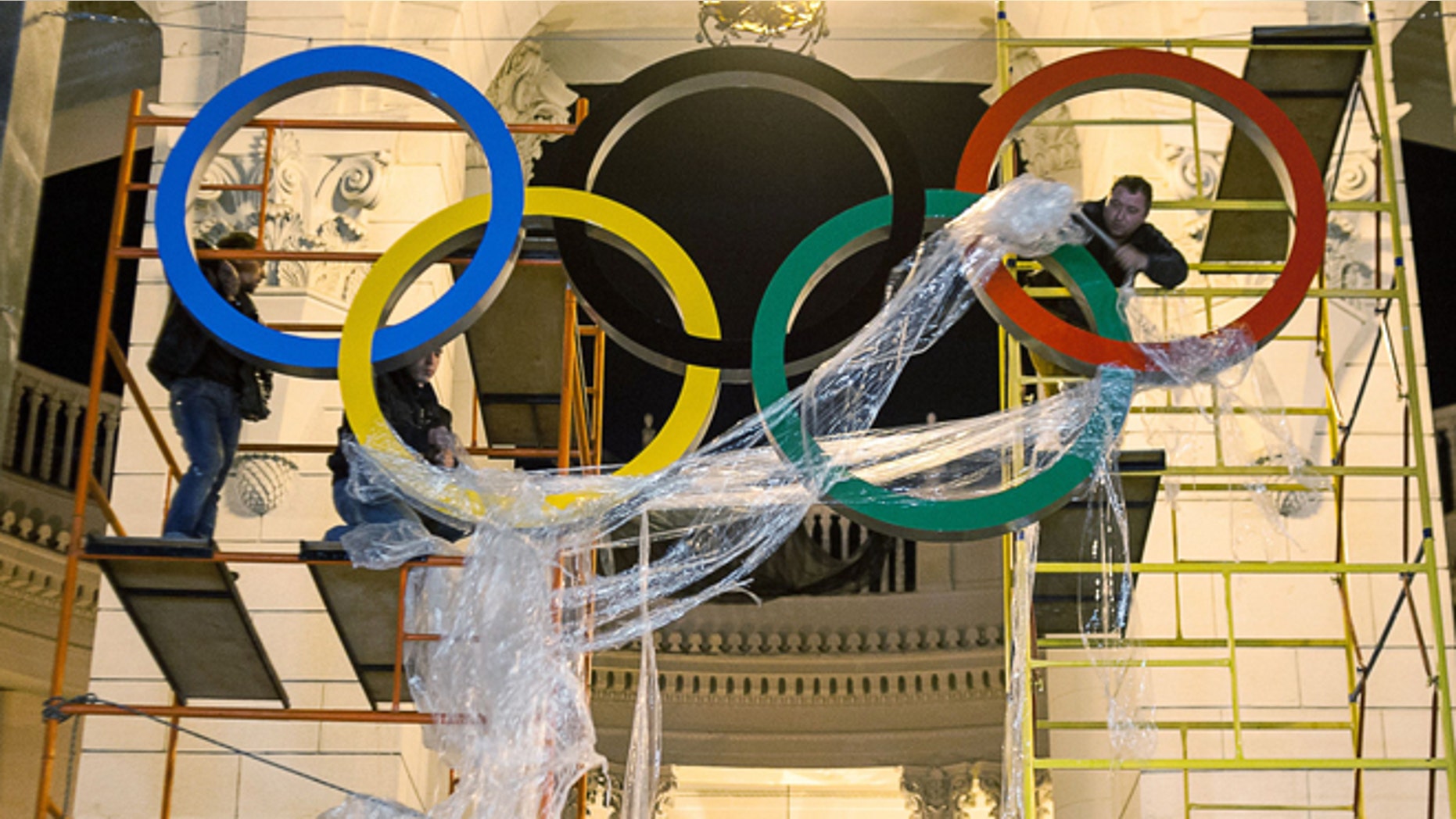 Oct. 28, 2013: Workers are fixing the Olympic emblem at an entrance to the railway station of Russia's Black Sea resort of Sochi, Russia.