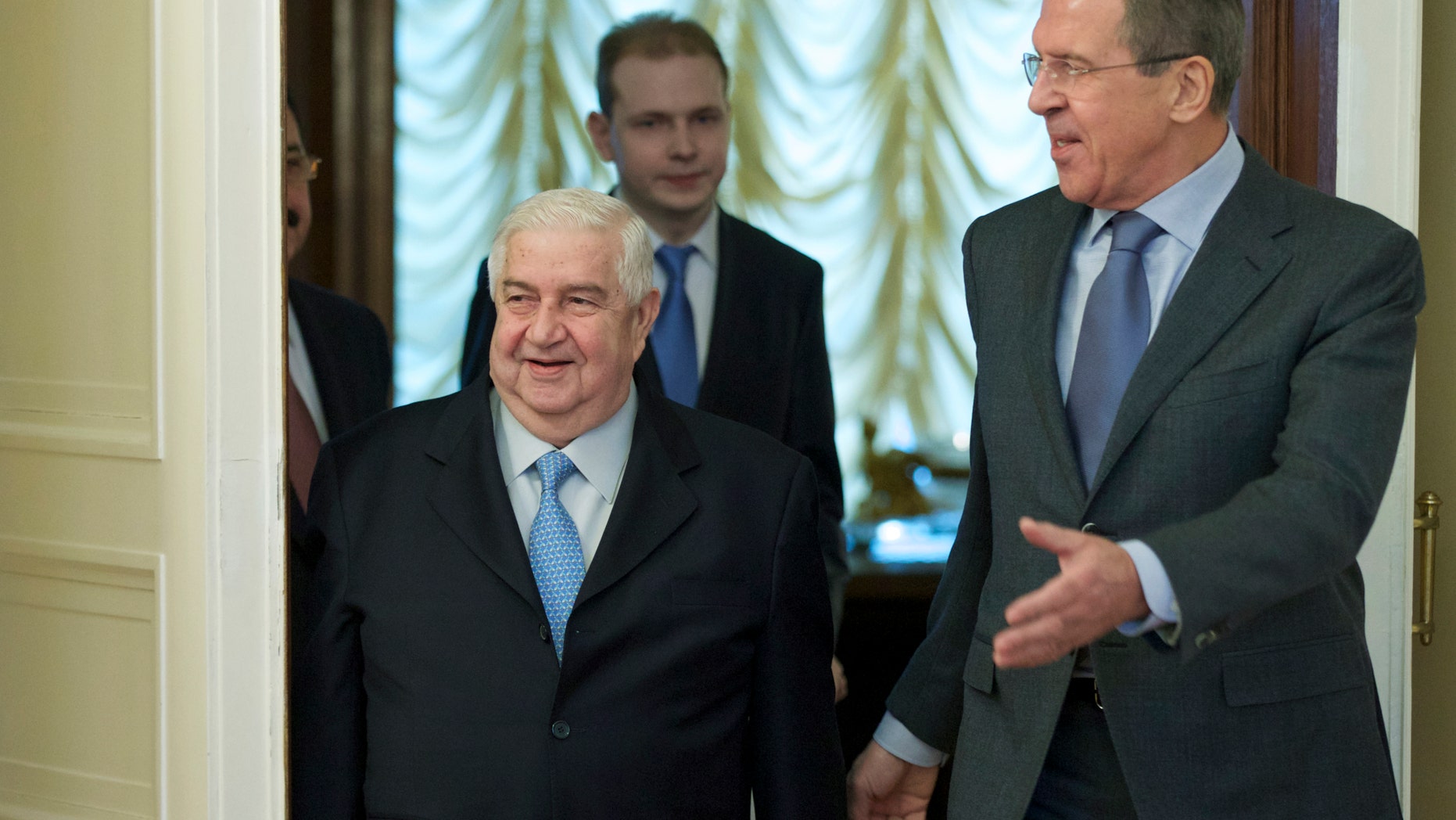 Jan. 17, 2014 - Russian Foreign Minister Sergey Lavrov, right, and his Syrian counterpart Walid al-Moallem arrive for talks in Moscow, Russia, on Syria. Foreign Minister said Friday that his country is prepared to implement a cease-fire in the war-torn city of Aleppo and exchange detainees with the country's opposition forces.