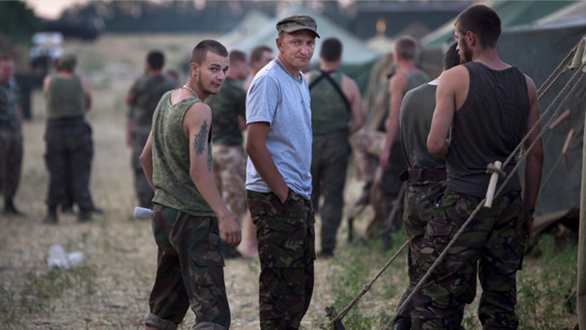 August 4, 2014: Ukrainian soldiers, who fled the conflict territory, spend their time at a tent camp near the Russia-Ukraine border just outside the village of Gukovo, Rostov-on-Don region, southern Russia. (AP Photo/Alexander Zemlianichenko)