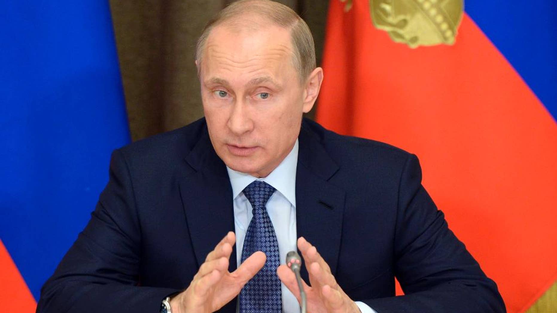FILE - In this May 12, 2015 file photo, Russian President Vladimir Putin speaks at a meeting with representatives of top military brass and defense industries at the Bocharov Ruchei residence in the Black Sea resort of Sochi, Russia. Putin signed a bill into law Saturday, May 23, 2015, giving prosecutors the power to declare foreign and international organizations "undesirable" in Russia and shut them down. (Alexei Nikolsky/RIA-Novosti, Kremlin Pool Photo via AP, File)
