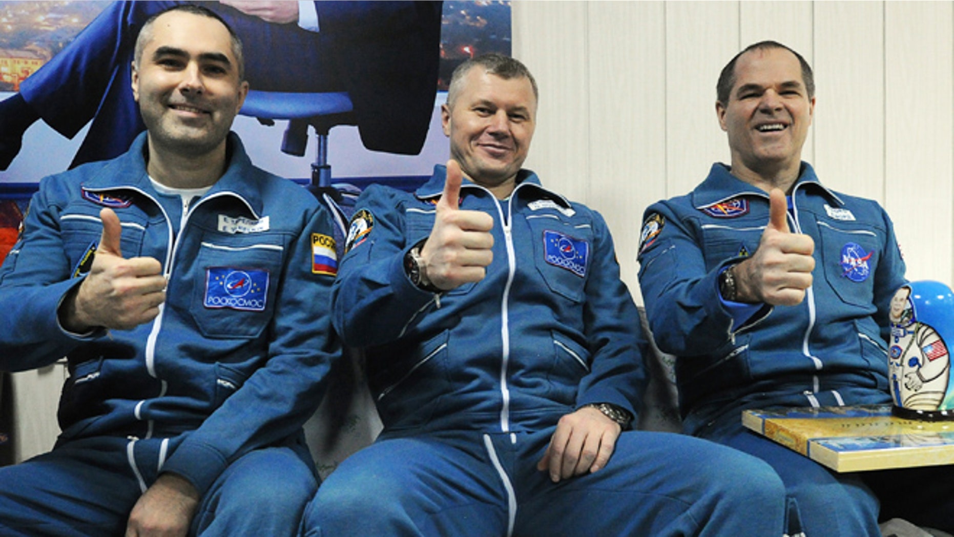 March 16, 2013: Russian cosmonauts Yevgeny Tarelkin, left, Oleg Novitsky, center, and NASA's astronaut Kevin Ford pose for a photo at the airport of the Kazakh city of Kostanai after their landing in northern Kazakhstan.