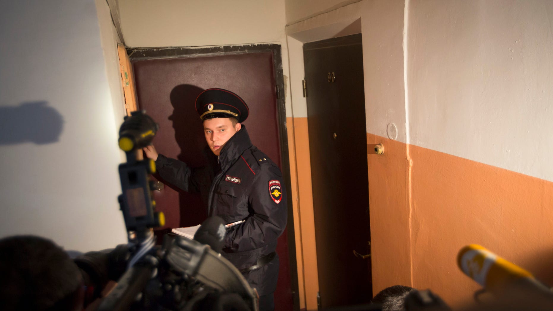 Oct. 12, 2015- Russian policeman speaks to the media in the building where homemade explosives were found in an apartment, in Moscow, Russia. Russia's counter-terrorism agency says it raided the apartment and arrested a group of people preparing to carry out an attack in the capital.