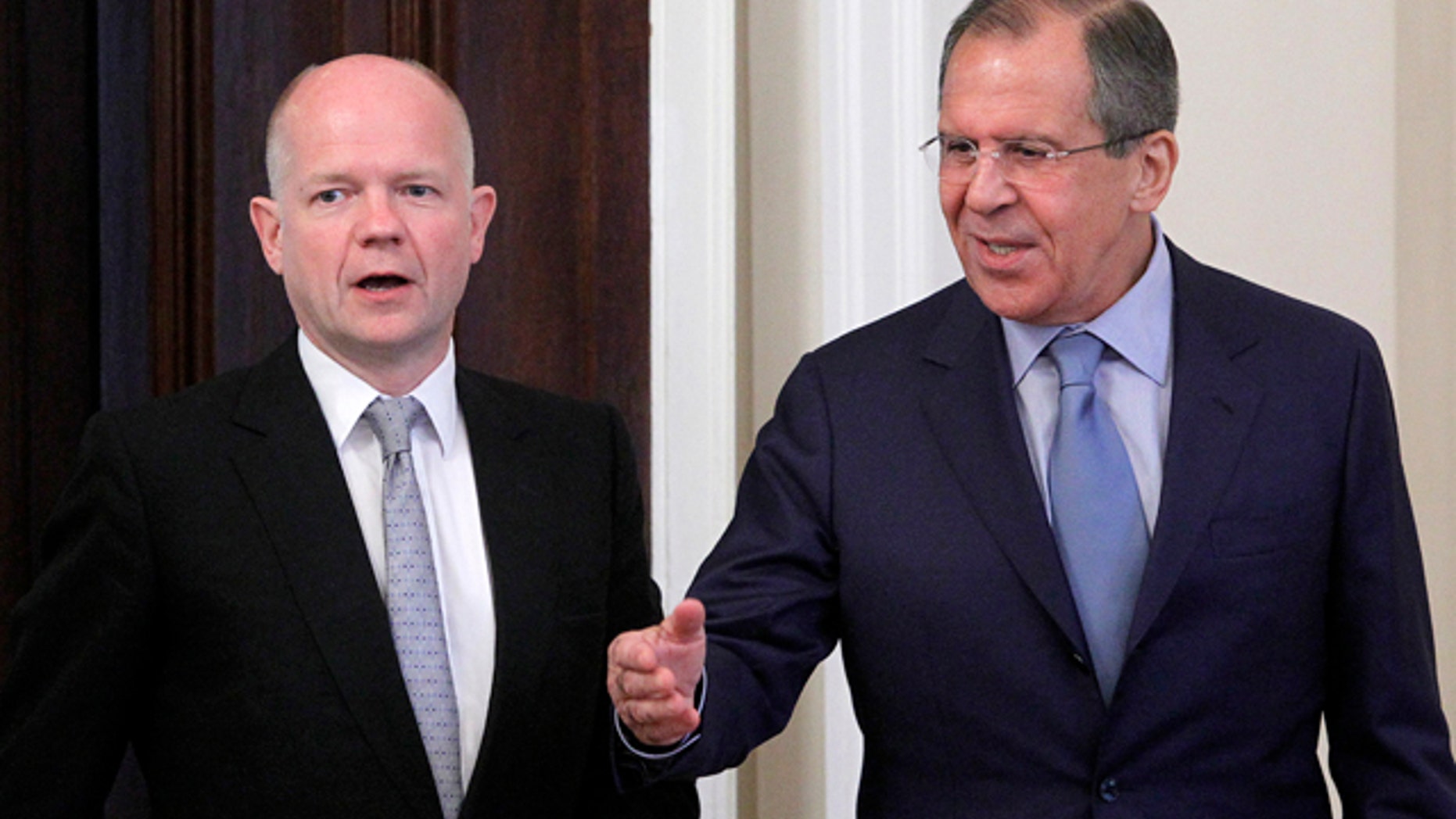 May 28: Russian Foreign Minister Sergey Lavrov, right, welcomes his British counterpart William Hague during their meeting in Moscow, Russia.