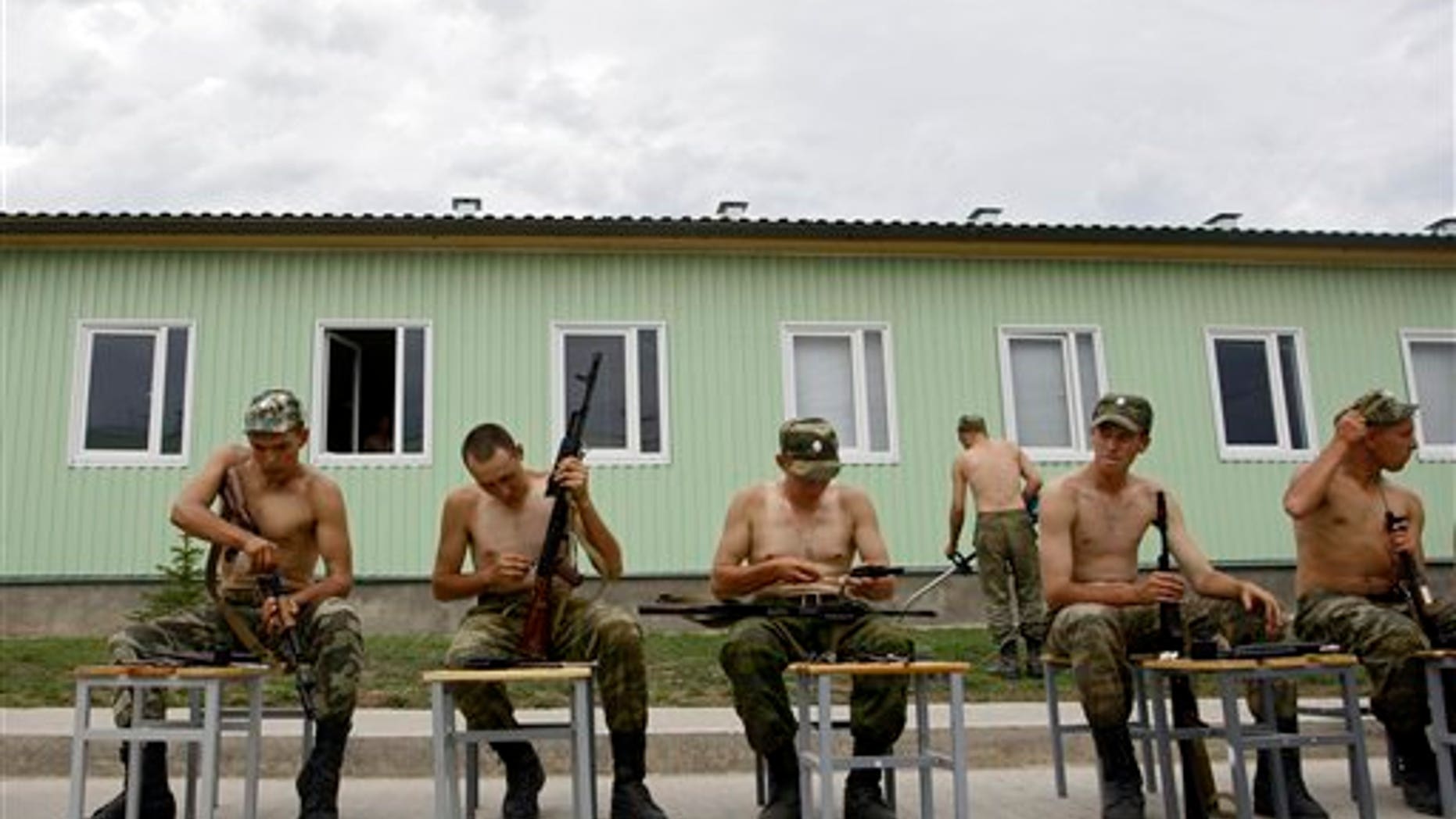 Russian soldiers clean their rifles at the military base in Tskhinvali, regional capital of Georgia's breakaway province of South Ossetia, Friday, Aug. 7, 2009. The separatist Georgian region marks the anniversary of the Georgian invasion that resulted in a brief Russia-Georgia war in Aug. 2008. (AP Photo/Sergey Ponomarev)