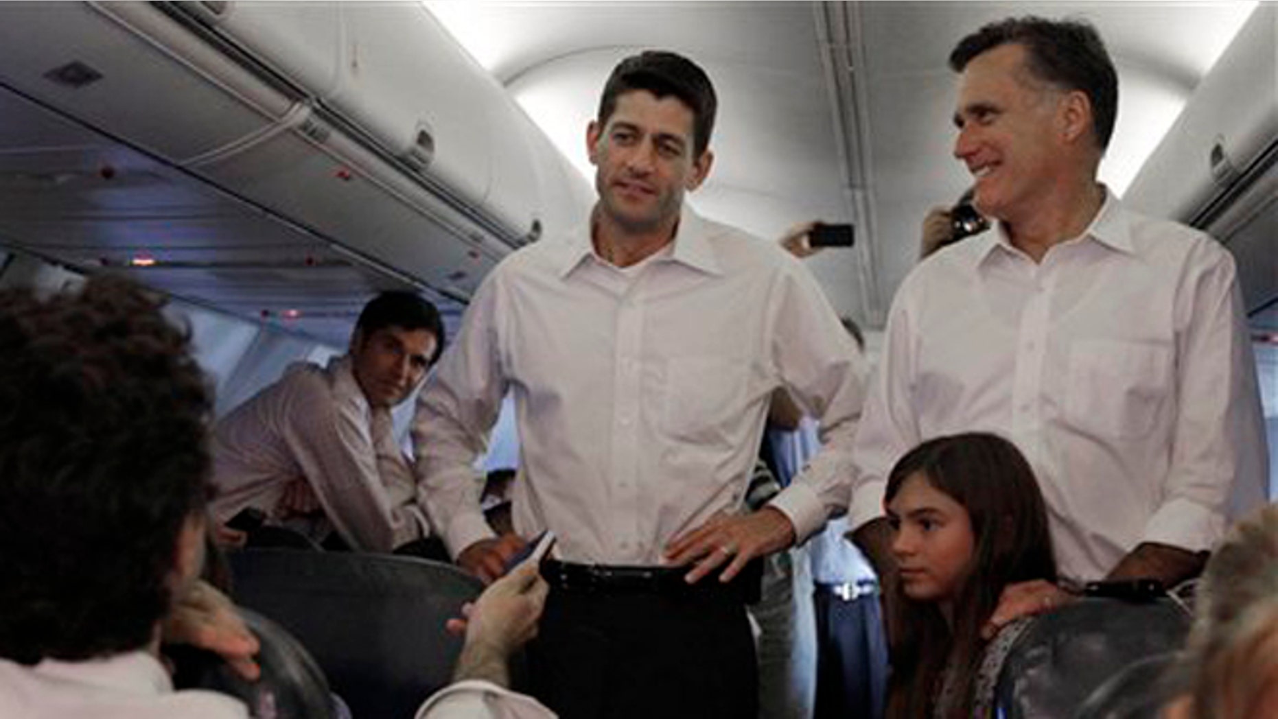 Aug. 11, 2012: Mitt Romney, right, and VP mate Rep. Paul Ryan, R-Wis. are joined by Romney's granddaughter Chloe on a flight between Virginia and North Carolina.