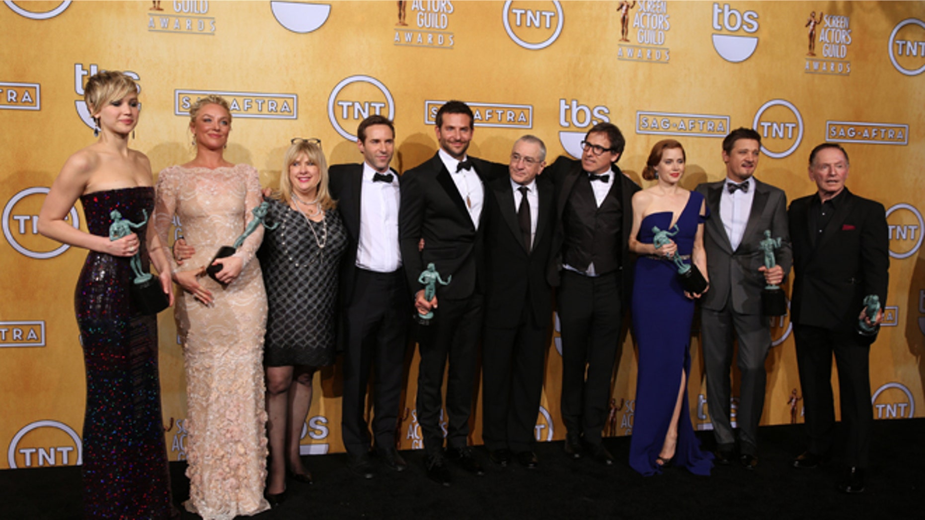 From left, Jennifer Lawrence, Elisabeth Rohm, Colleen Camp, Alessandro Nivola, Bradley Cooper, Robert De Niro, David O. Russell, Amy Adams, Jeremy Renner and Paul Herman pose in the press room with the award for outstanding performance by a cast in a motion picture for âAmerican Hustleâ at the 20th annual Screen Actors Guild Awards at the Shrine Auditorium on Saturday, Jan. 18, 2014, in Los Angeles. (Photo by Matt Sayles/Invision/AP)