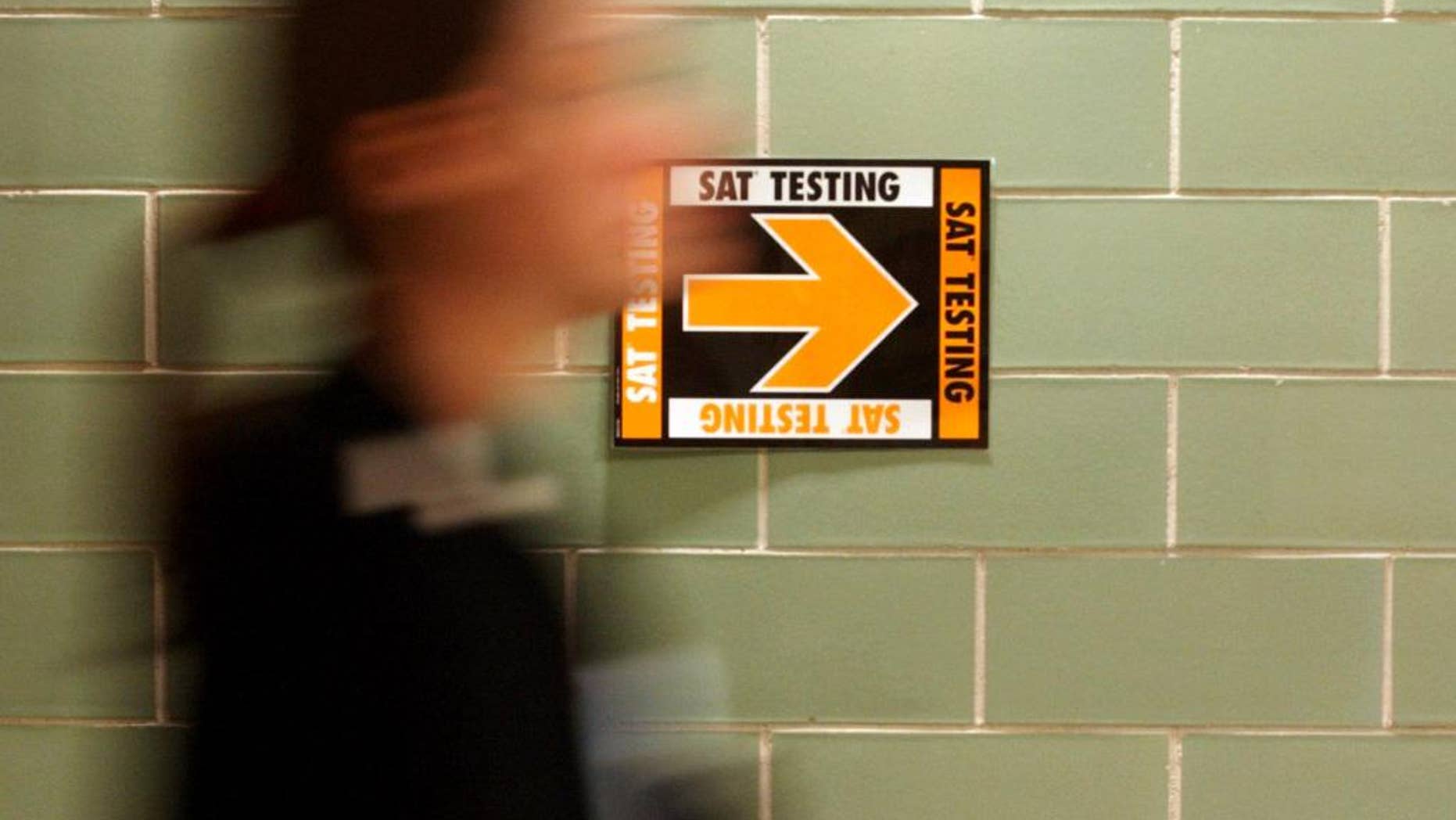File- This March 12, 2005, file photo shows a student leaving after taking the SAT at Upper Arlington High School in Upper Arlington, Ohio. Student performance on the SAT college entrance exam is lagging, continuing a mostly downward trend over the last five years. The College Board says in a report that a record number of students took the exam. (AP Photo/Paul Vernon, File)