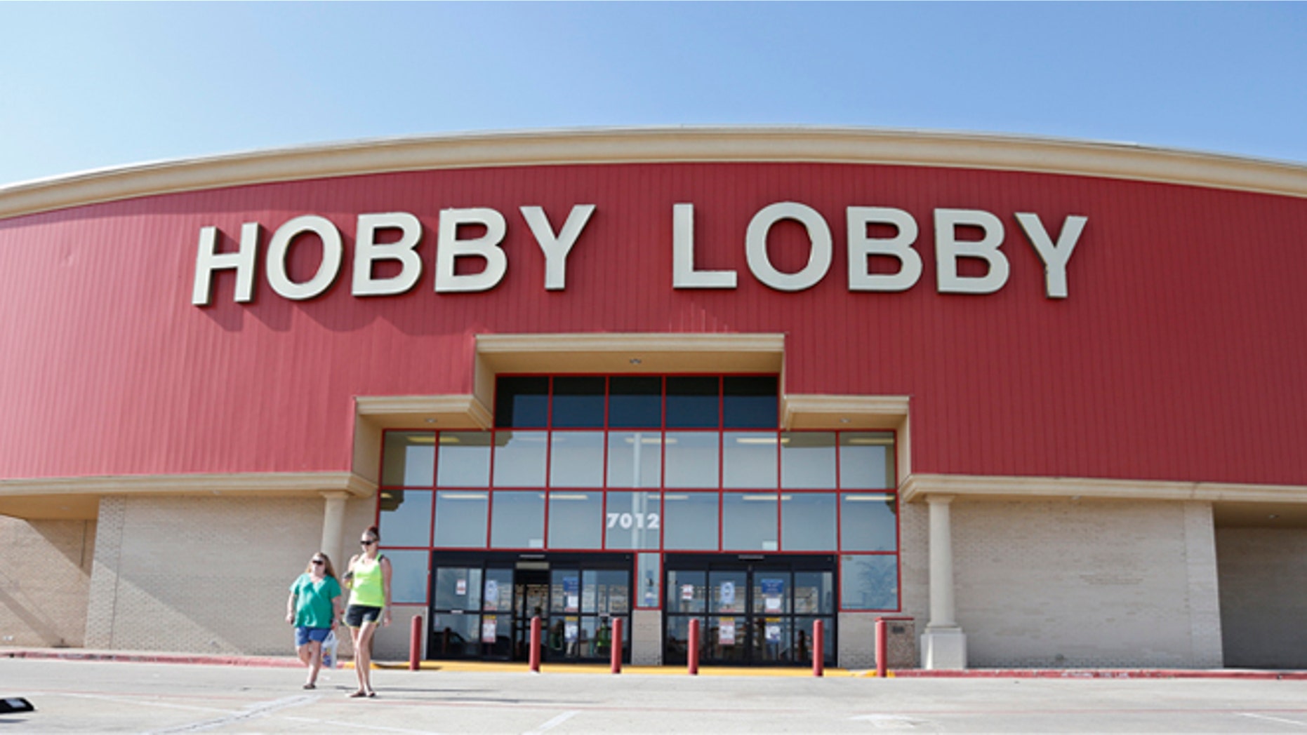 Customers leave a Hobby Lobby store in Oklahoma City, Monday, June 30, 2014. The Supreme Court ruled Monday that employers can hold religious objections that allow them to opt out of the new health law requirement that they cover contraceptives for women. The Hobby Lobby chain of arts-and-crafts stores is by far the largest employer of any company that has gone to court to fight the birth control provision. (AP Photo/Sue Ogrocki)