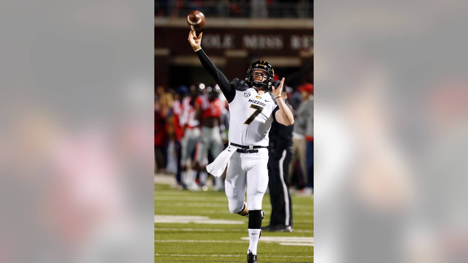 FILE - In this Nov. 23, 2013, file photo, Missouri quarterback Maty Mauk (7) throws downfield to a receiver during pregame drills before their NCAA college football game against Mississippi, in Oxford, Miss. Mauk is one of the SEC’s new starting quarterbacks. (AP Photo/Rogelio V. Solis, File)