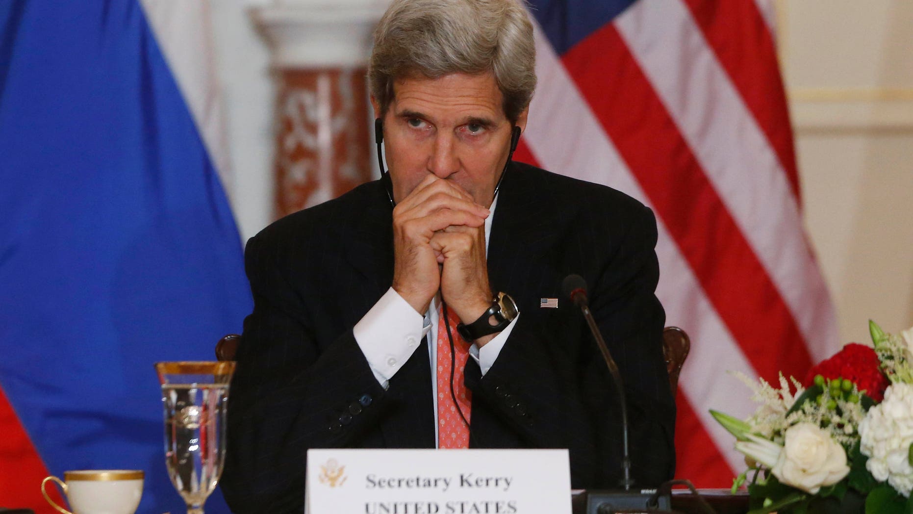 In this photo taken Aug. 9, 2013, Secretary of State John Kerry listens to translation as he meets with Russian Foreign and Defense ministers at the State Department in Washington, a sit-down tainted by the case of American National Security Agency leaker Edward Snowden, currently in Russia. This week on Kerry's first visit to South America as the Obama administration's chief diplomat, the disclosures by Snowden could chill talks on trade and energy, and even discussions about the Oct. 23 state dinner that President Barack Obama is hosting for Brazil's president, Dilma Rousseff. (AP Photo/Charles Dharapak)