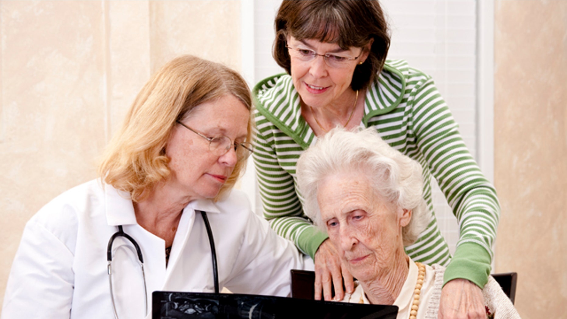 Senior woman visiting with her doctor or caregiver