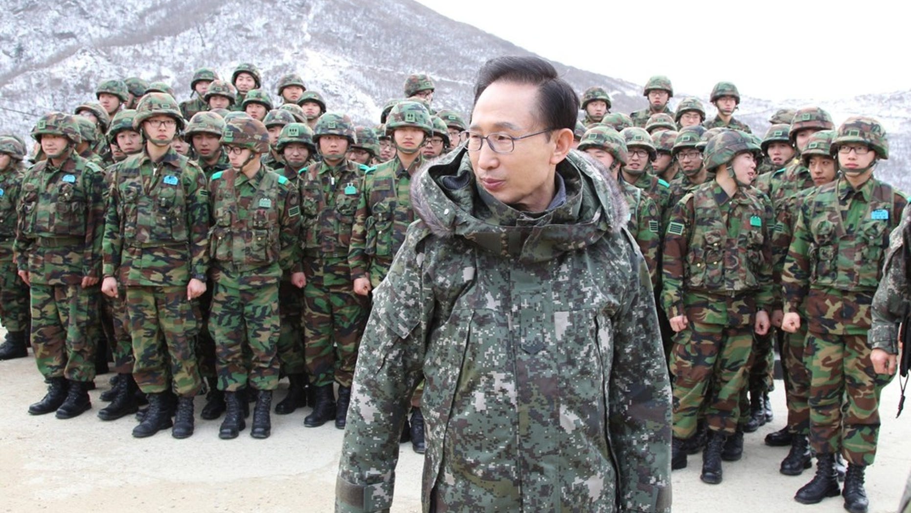 Dec. 23, 2010: South Korean President Lee Myung-bak leaves after taking photographs with soldiers during his visit to a military observation post of the front-line unit in the demilitarized zone in Yanggu, far northeast of Seoul.