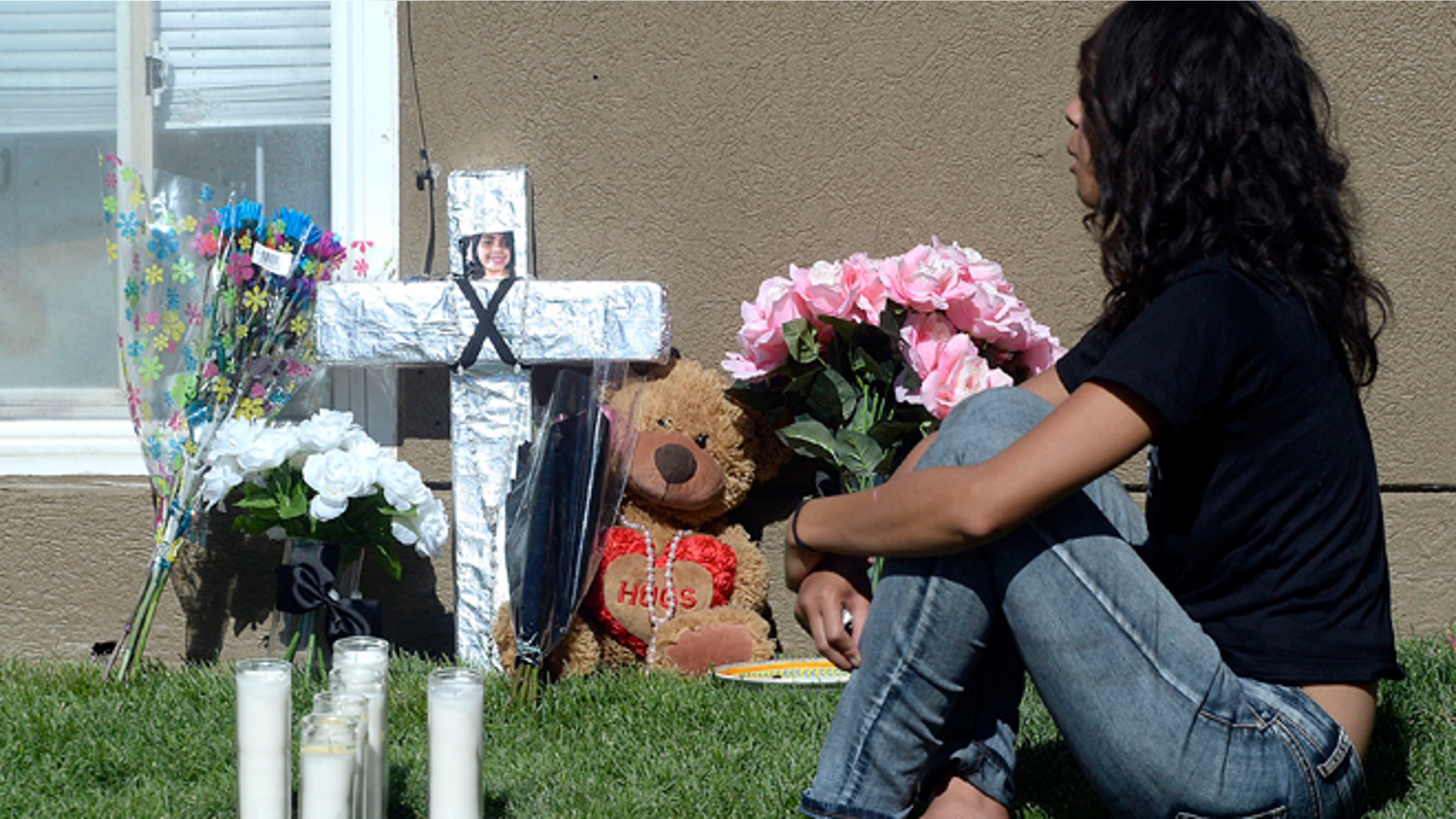 Friends and family mourn at a memorial for sixteen-year-old Jose Izazaga and his 15-year-old sister Abril Izazaga, Thursday, July 7, 2016 in Midvale, Utah. As police search for a man who police say gunned down a teenage brother and sister during an argument over a T-shirt late Wednesday at a Salt Lake City suburb apartment complex, family members are mourning the senseless killing of siblings who shared a tight bond. (Al Hartmann/The Salt Lake Tribune via AP)