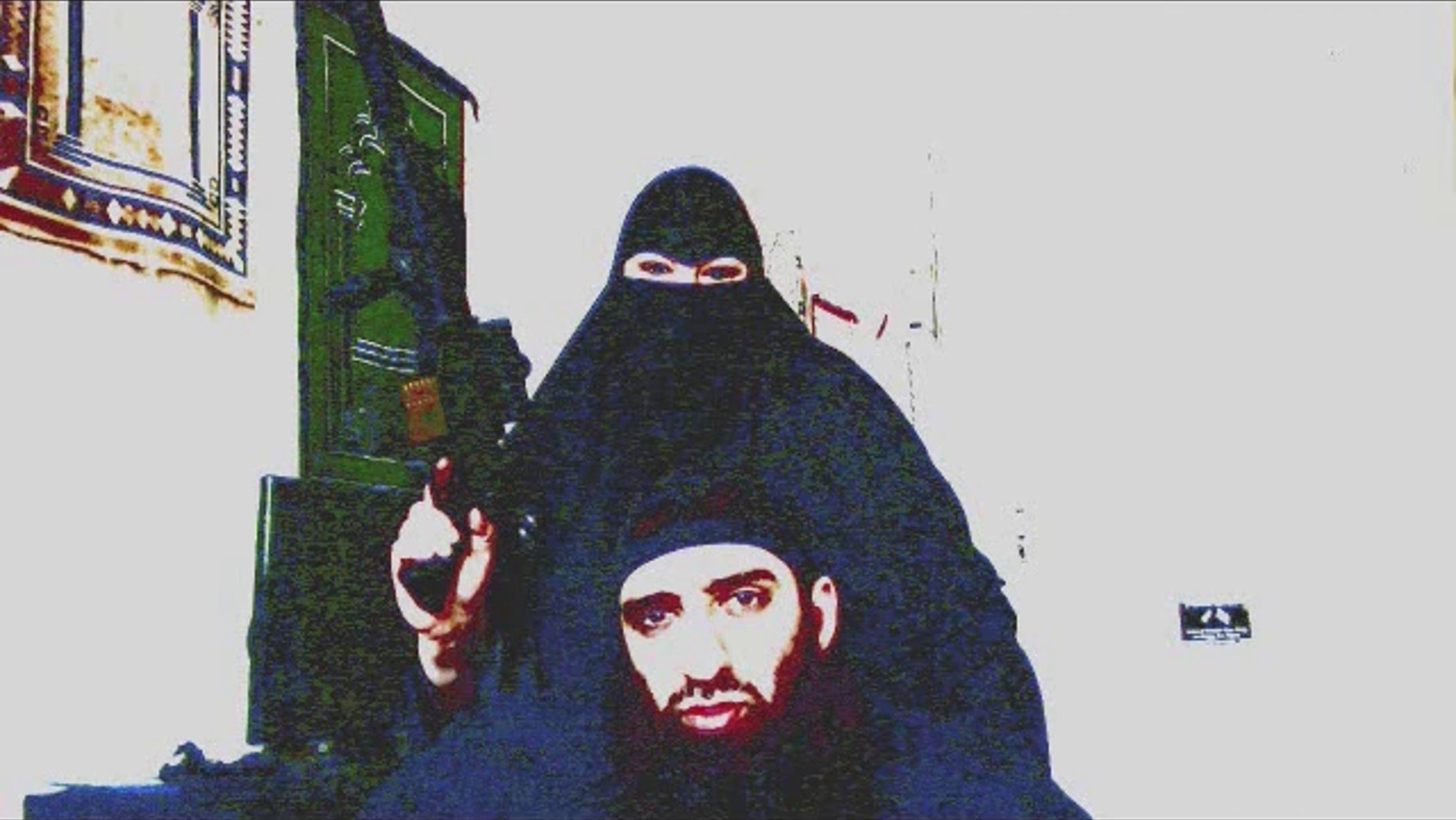 Kathie Smith brandishes a gun in video starring her and her husband, Salahudin Ibn Jafar, that is being investigated by terrorism task force.