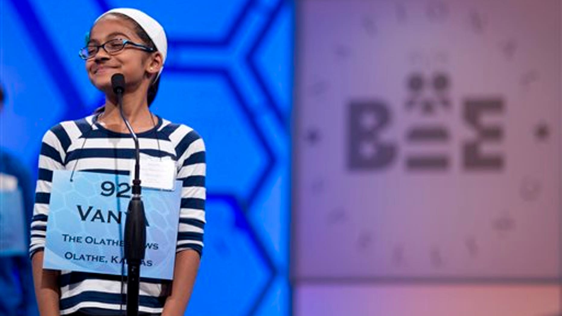 This May 30, 2012, file photo shows Vanya Shivashankar, of Olathe, Kan., smiling as she answers her question during the third round of the National Spelling Bee in Oxon Hill, Md. (AP Photo/Evan Vucci, File)