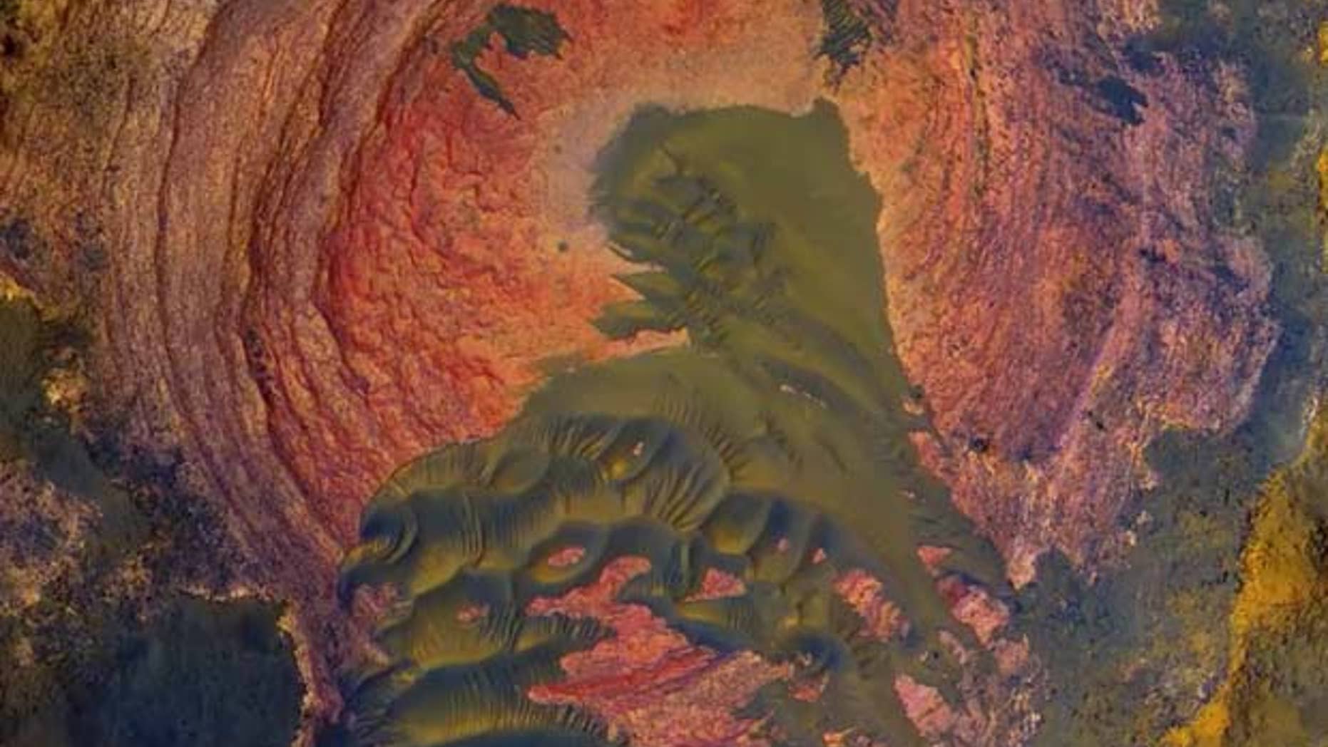 NASA's Mars Reconnaissance Orbiter has captured stunning images of the Red Planet, including some views that look very similar to vistas on Earth like this view of Martian bedrock and sand dunes.