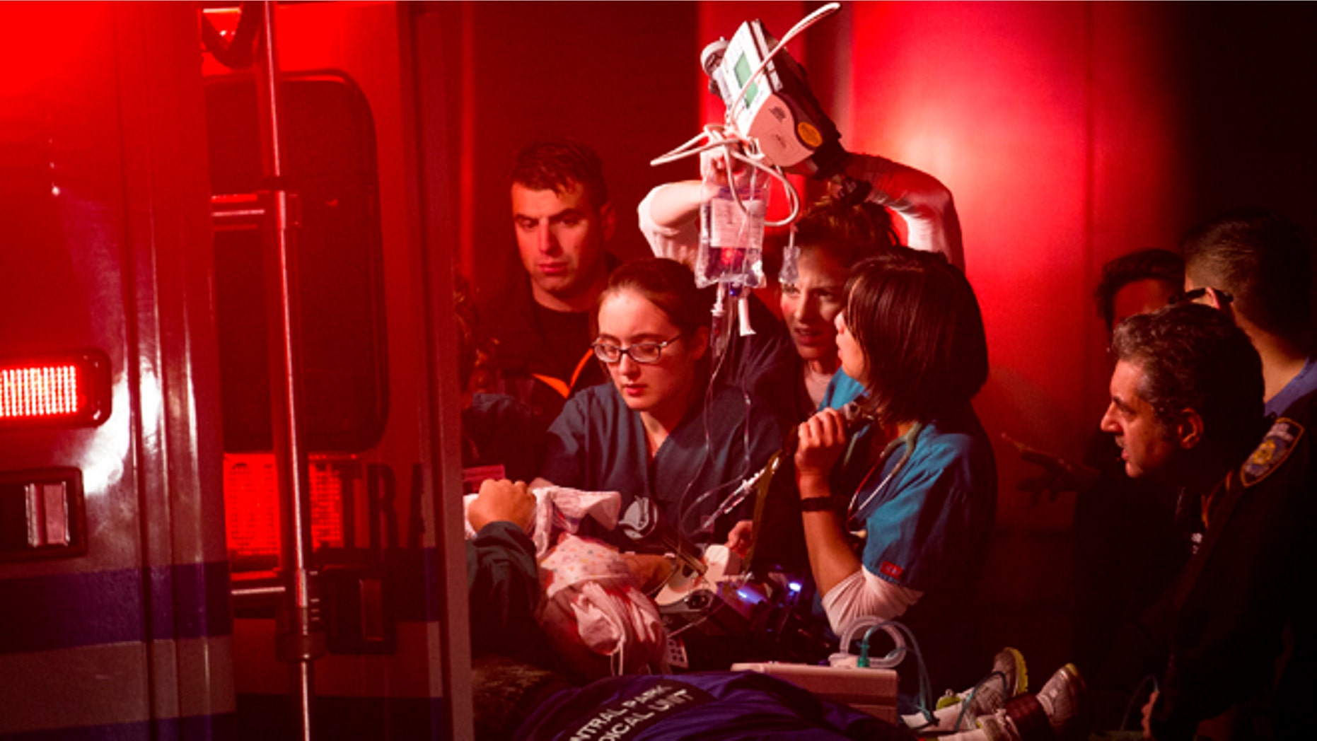 Medical workers assist a patient into an ambulance during an evacuation of New York University's Tisch Hospital, Monday, Oct. 29, 2012, in New York. The New York City hospital is moving out more than 200 patients after its backup generator failed when the power was knocked out by a superstorm. (AP Photo/ John Minchillo)