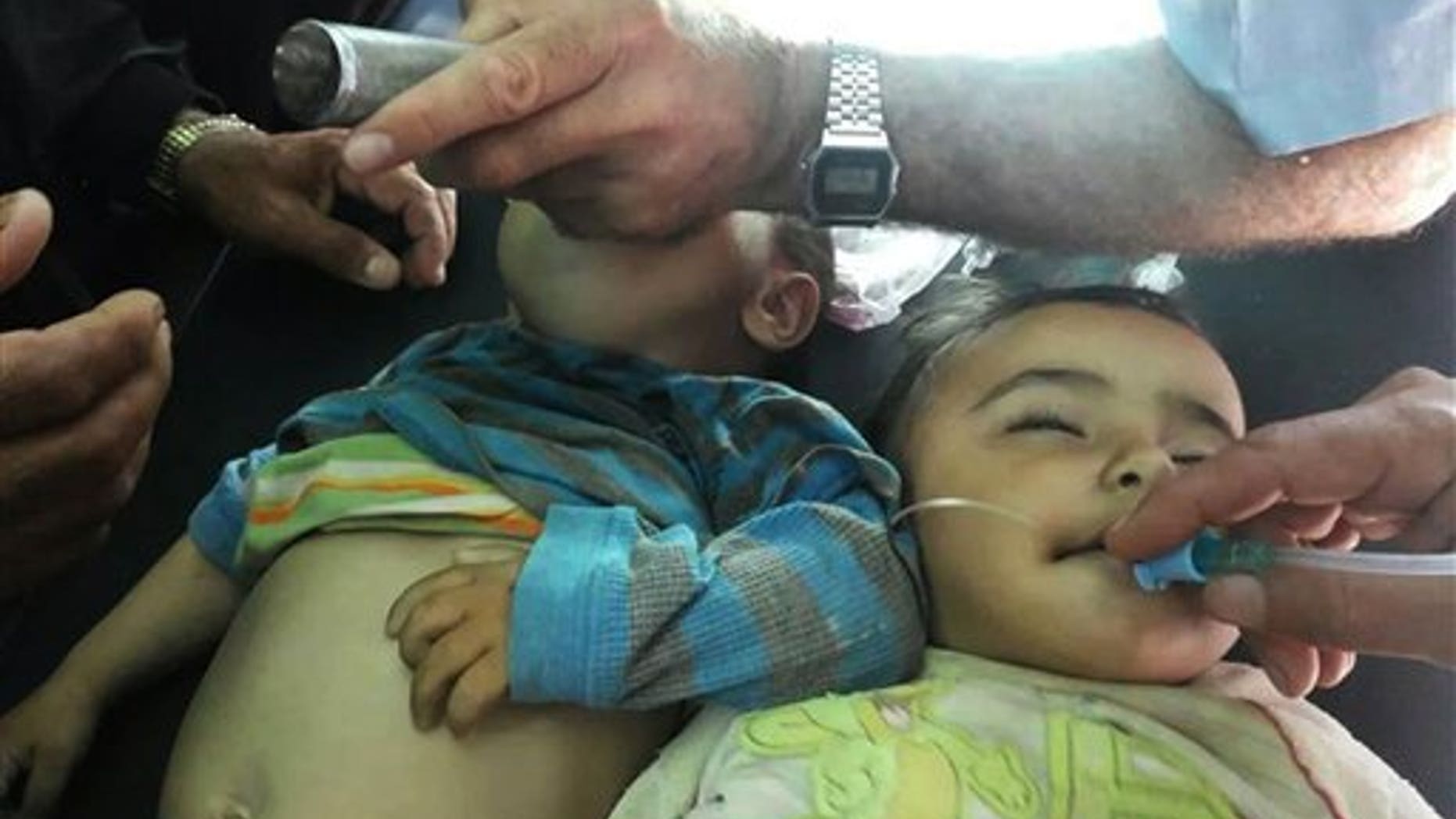 Sept. 17, 2014: Two Syrian children receive treatment after they were given a second round of measles vaccinations, in Idlib province. At least 15 children died after receiving vaccinations in rebel-held parts of Syria.