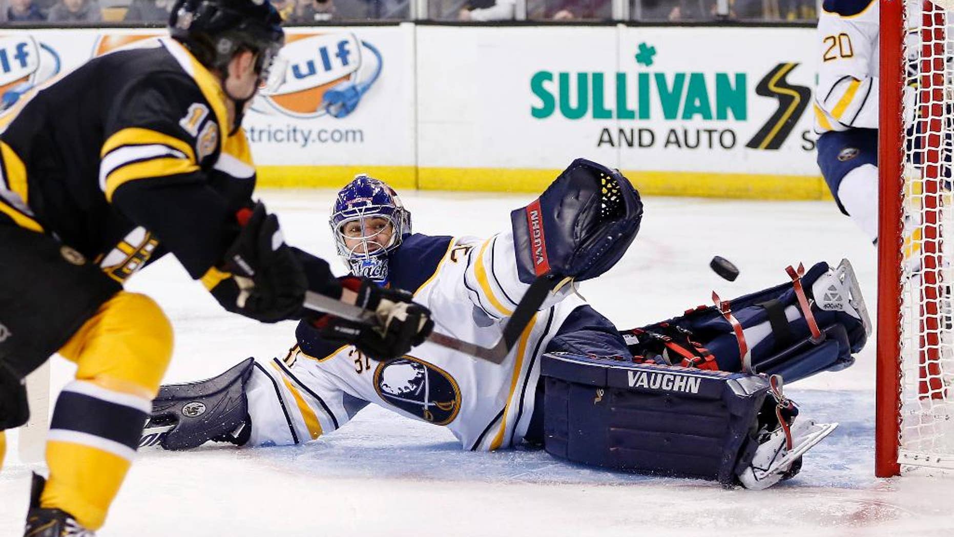 Boston Bruins' Reilly Smith (18) shoots wide of Buffalo Sabres' Matt Hackett (31) during the second period of an NHL hockey game in Boston, Saturday, April 12, 2014. (AP Photo/Michael Dwyer)