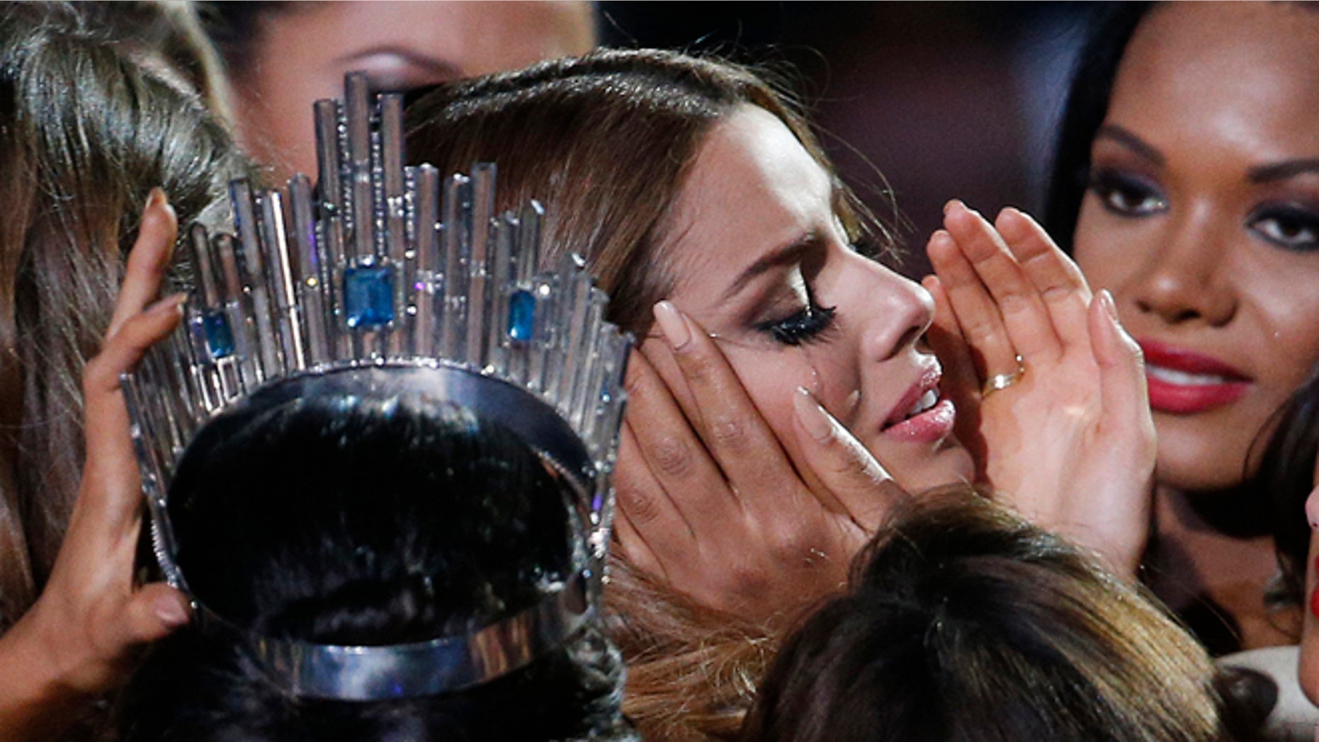 Contestants comfort Miss Colombia Ariadna Gutierrez after she was incorrectly crowned Miss Universe on Dec. 20, 2015.