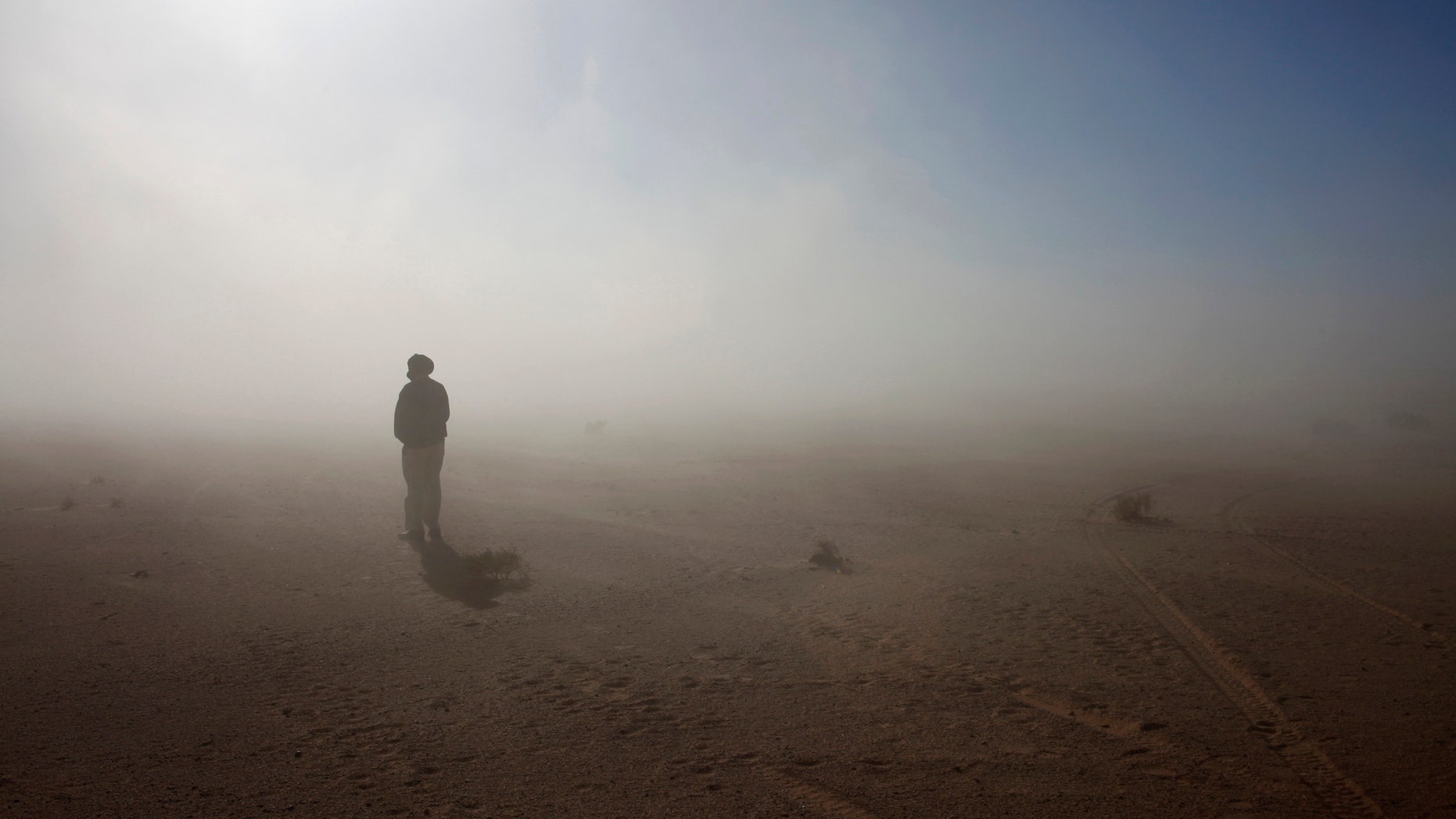 File photo - A Sahrawi man stands in the Sahara desert between Tindouf and Tifariti,