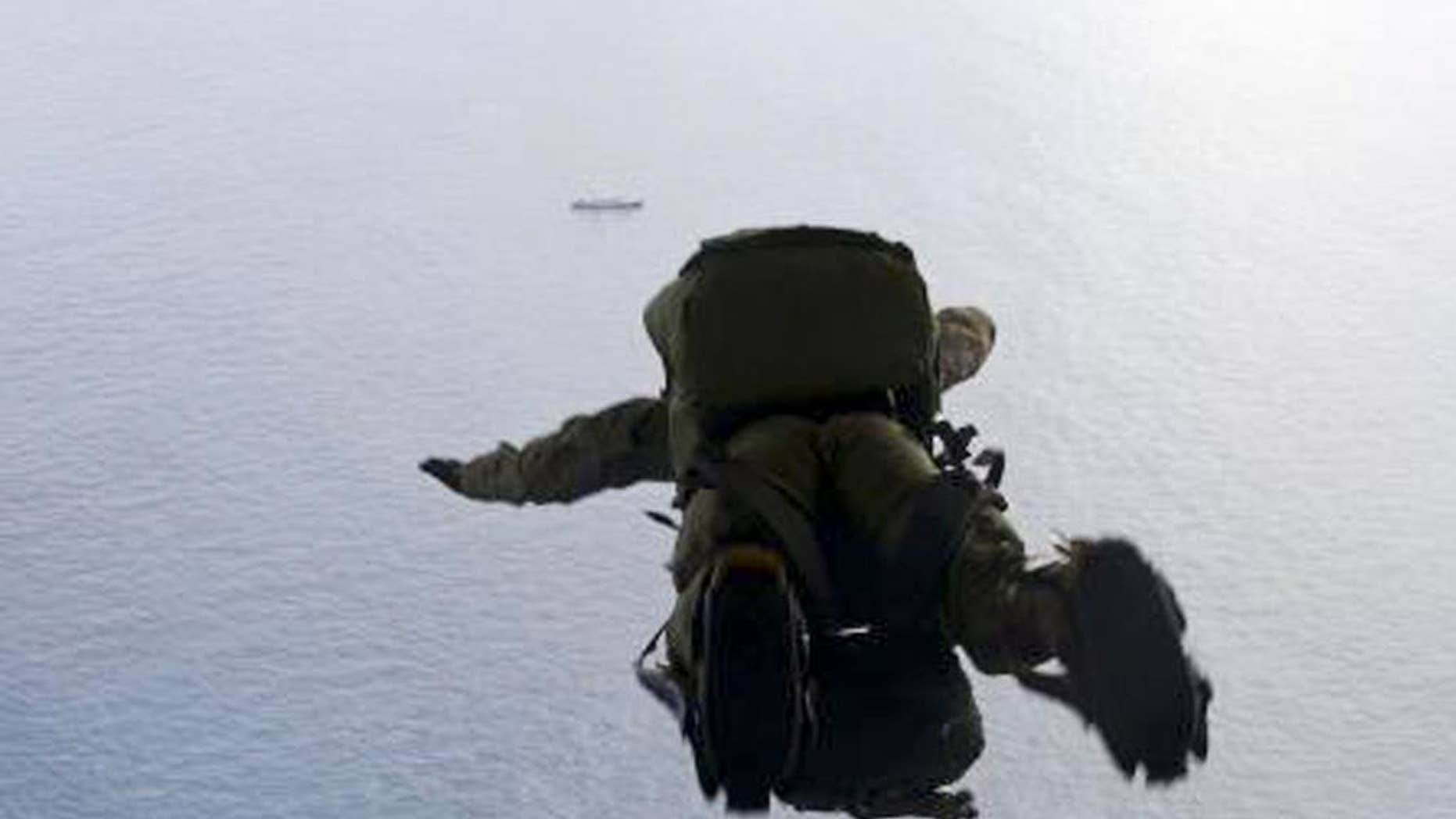 In this May 3, 2014, image provided by the U.S. Air Force, a U.S. Air Force Airman parachutes into the Pacific Ocean to aid two critically injured sailors aboard a Venezuelan fishing boat. The Venezuelan fishing boat found the sailors floating in a raft Friday afternoon after their vessel sank off the coast of Mexico, said Sarah Schwennese, spokeswoman at the Davis-Monthan Air Force Base in Tucson. (AP Photo/U.S. Air Force, Staff Sgt. Adam Grant)