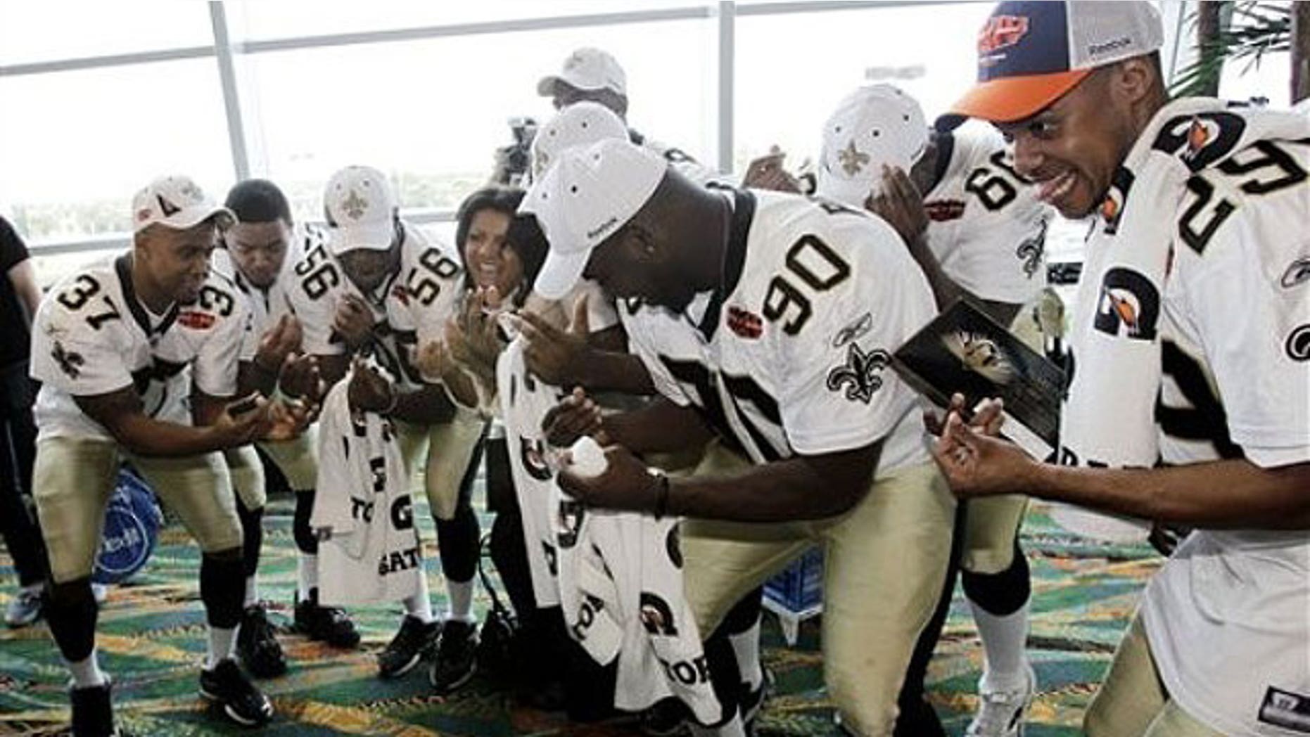 Some of the New Orleans Saints get down at a Super Bowl press conference. (AP)