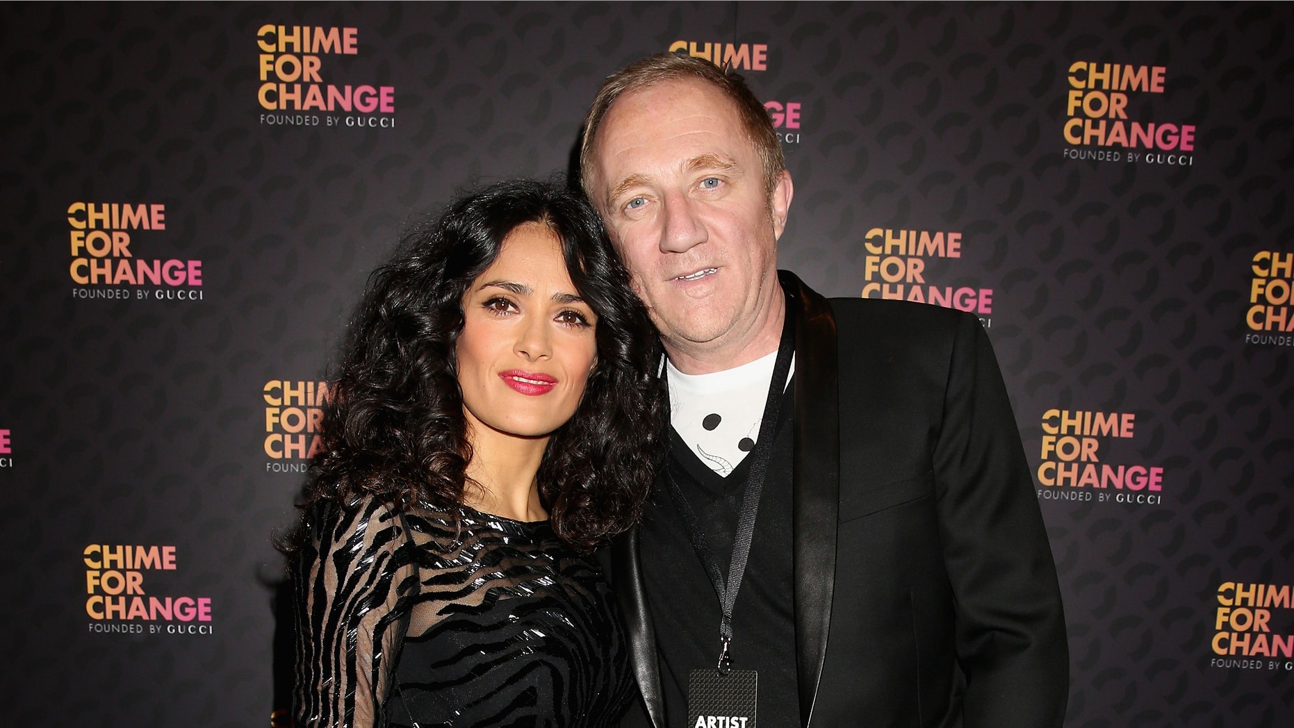 Salma Hayek Pinault and Francois Henri Pinault arrive at the Royal Box photo wall ahead of the "Chime For Change: The Sound Of Change Live" Concert at Twickenham Stadium on June 1, 2013 in London, England.