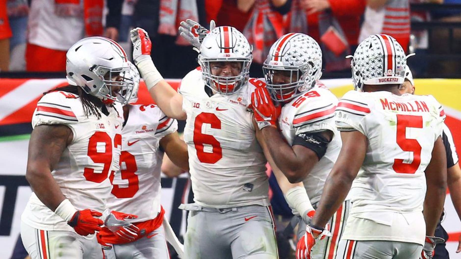 Jan 1, 2016; Glendale, AZ, USA; Ohio State Buckeyes defensive end Sam Hubbard (6) celebrates with teammates after a tackle in the second half against the Notre Dame Fighting Irish during the 2016 Fiesta Bowl at University of Phoenix Stadium. The Buckeyes defeated the Fighting Irish 44-28. Mandatory Credit: Mark J. Rebilas-USA TODAY Sports