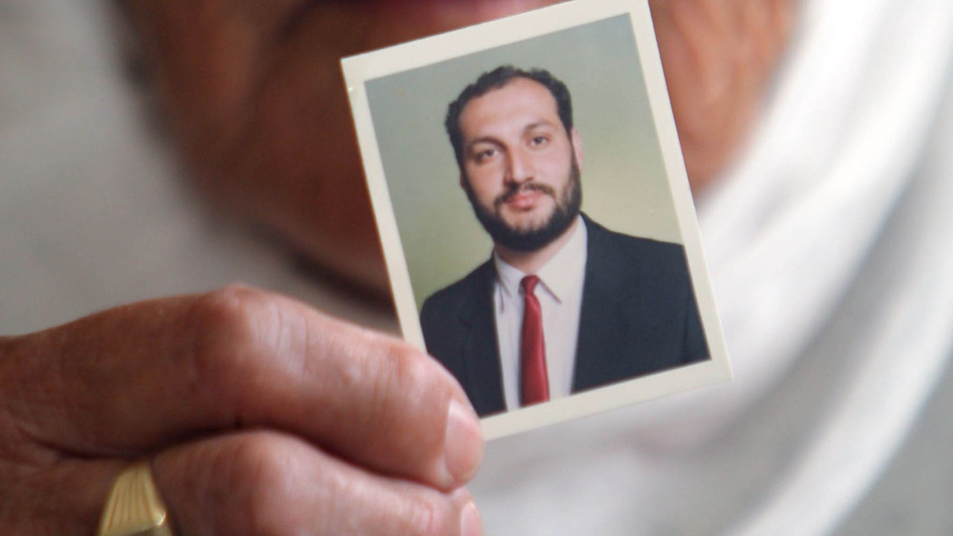 August 16: Wajeeha Allawi, 76, mother of Al-Jazeera reporter Samer Allawi holds a picture of her son inside her home in the West Bank city of Nablus. Israel has arrested the Palestinian journalist who works for the Arabic language Al-Jazeera satellite network. A journalists' advocacy group says he is being held without charges.