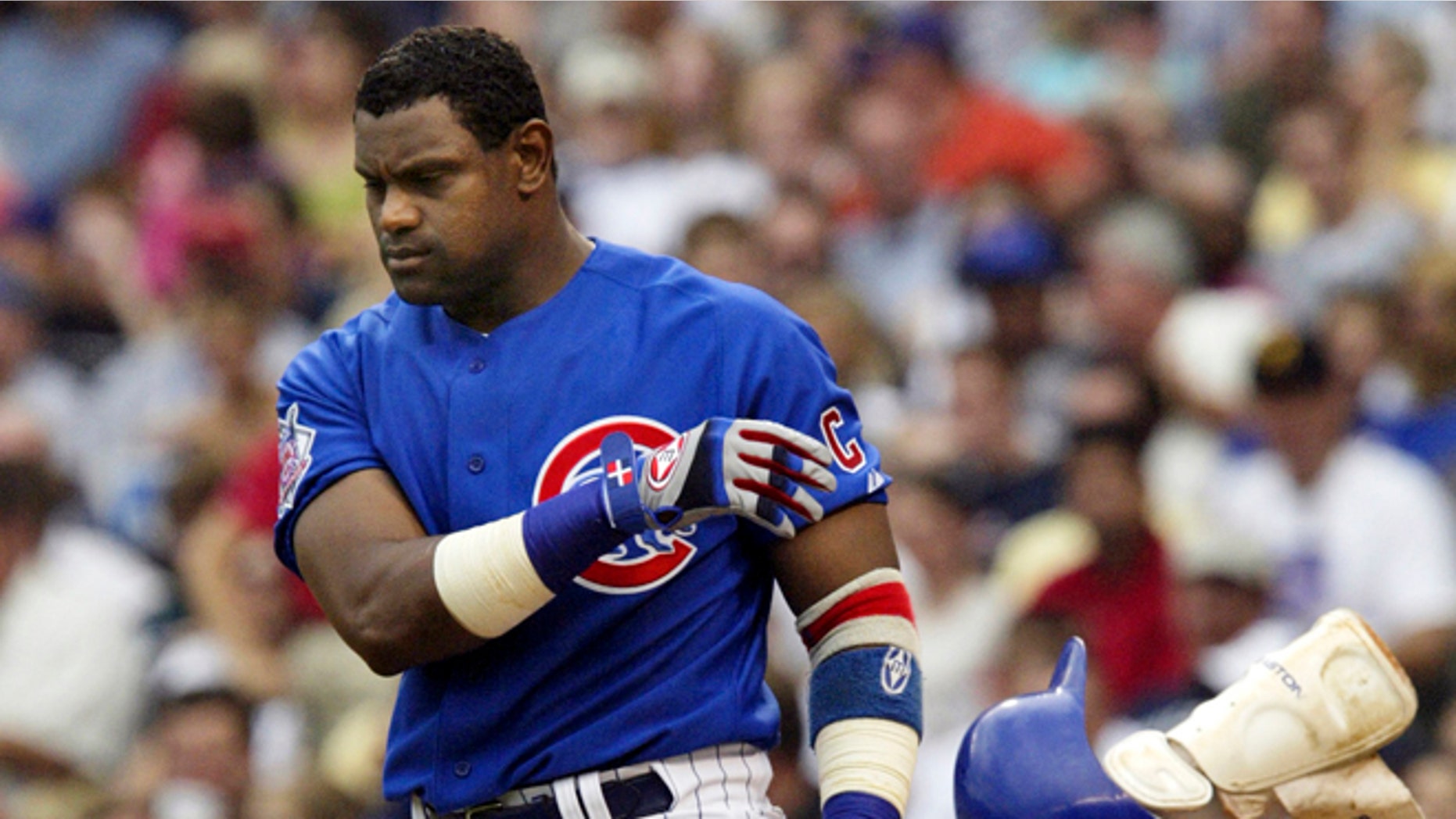 June 18, 2004: In this file photo, Chicago Cubs' Sammy Sosa tosses his helmet and shin guard after striking out to end the sixth inning against the Oakland Athletics during a baseball game in Chicago.