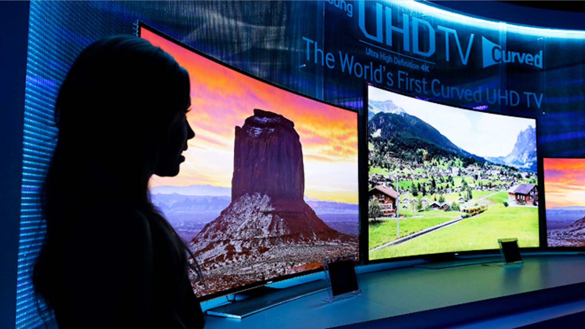 Jan. 5, 2014: A model stands next to a display of Samsung's curved 4K UHD TVs during a preview event at the International Consumer Electronics Show in Las Vegas.