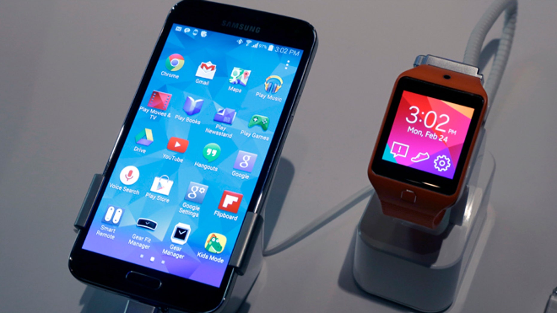 A Samsung Galaxy S5 smartphone, left, and a Samsung Gear 2 are displayed at the Samsung Galaxy Studio, in New York, Monday, Feb. 24, 2014. Samsung on Monday unveiled a new smartphone with a built-in heart rate monitor to complement three upcoming fitness devices, as the Korean company tries to turn its technological wizardry into lifestyle products. (AP Photo/Richard Drew)