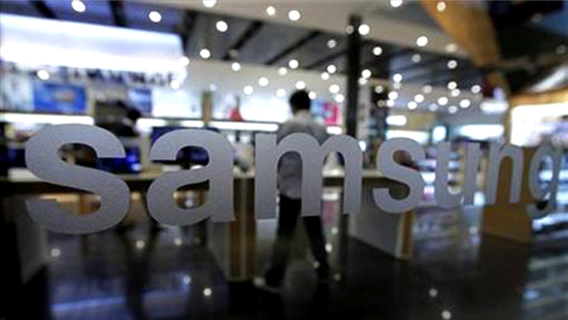 A customer looks at Samsung Electronics' products at a shop at the company's headquarters in Seoul October 7, 2011.