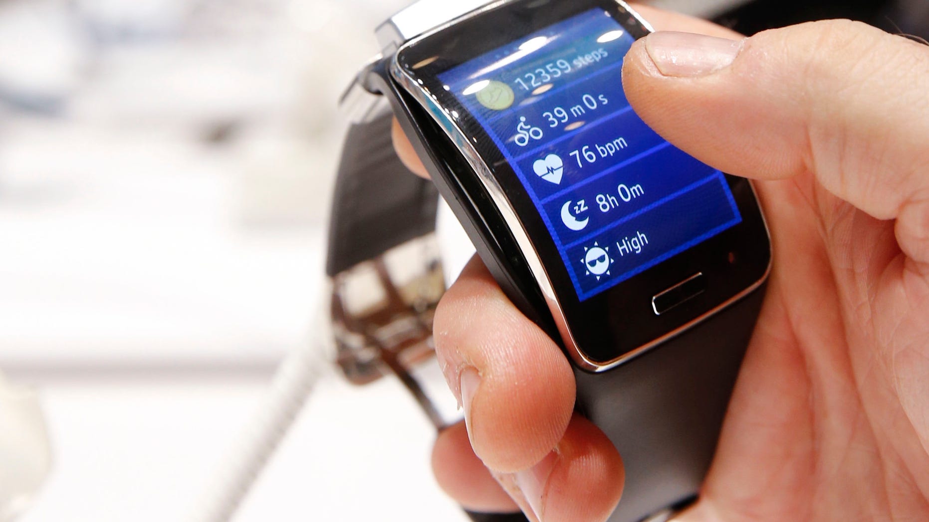 A visitor holds a Samsung Gear S smartwatch at the IFA consumer technology fair in Berlin, September 5, 2014.