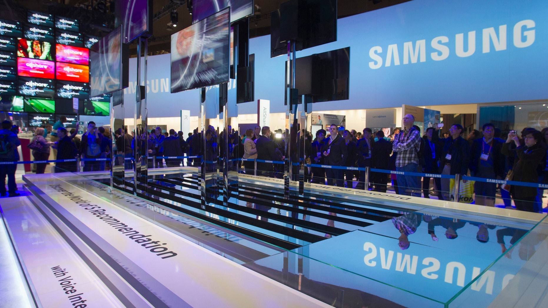 File photo - Showgoers watch a display of Samsung Smart TVs during the first day of the Consumer Electronics Show (CES) in Las Vegas Jan. 8, 2013.
