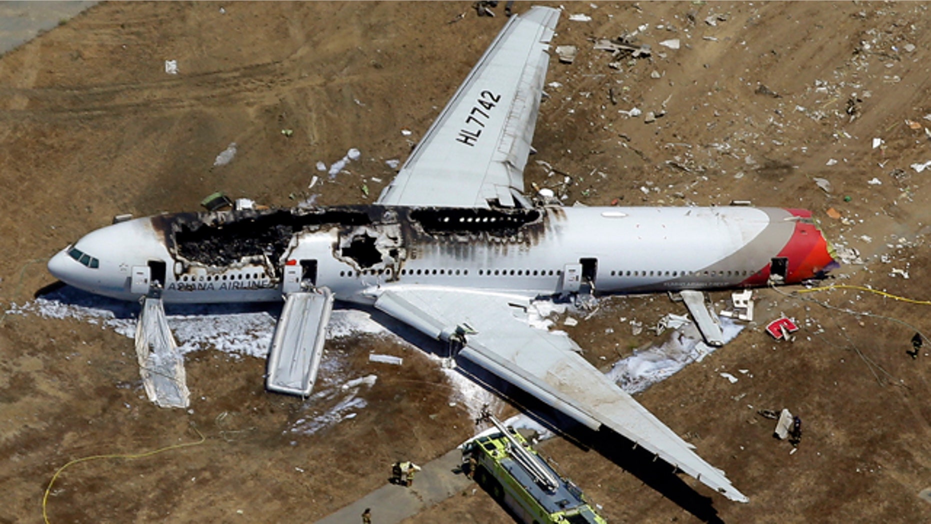 FILE - In this July 6, 2013 aerial file photo, the wreckage of Asiana Flight 214 lies on the ground after it crashed at the San Francisco International Airport in San Francisco. (AP Photo/Marcio Jose Sanchez, File)