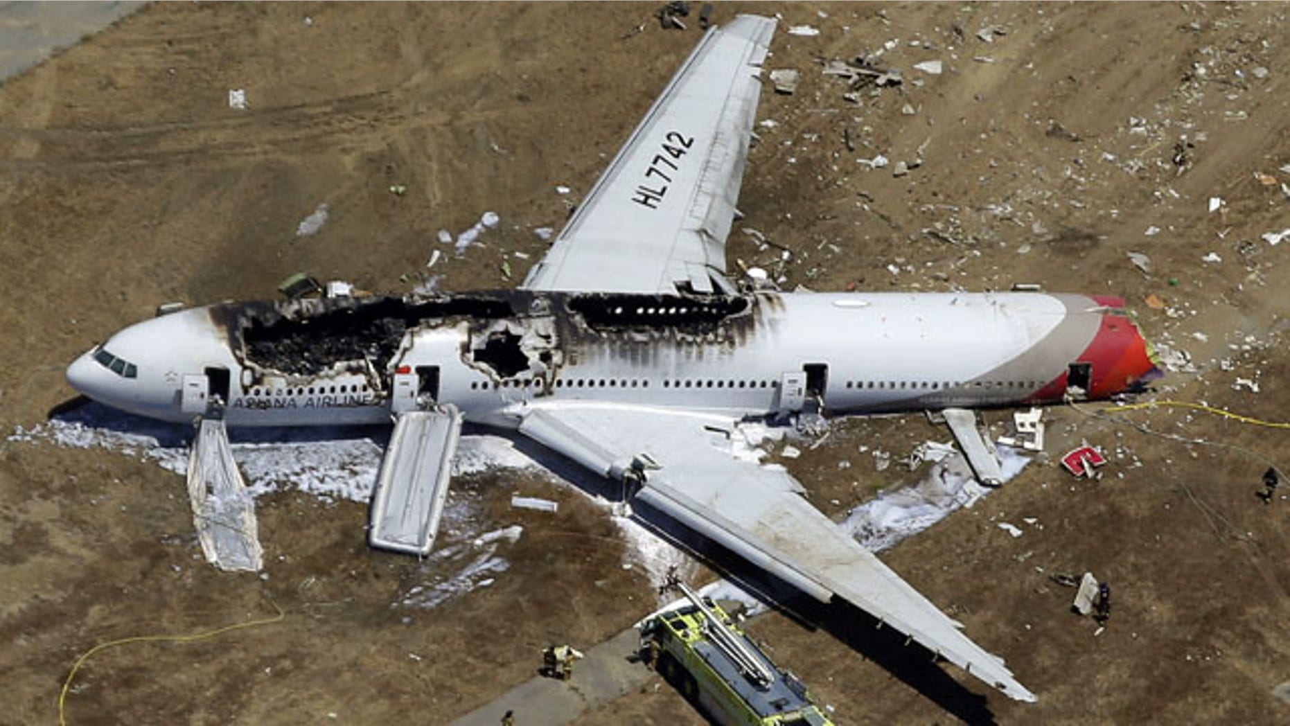 In this July 6, 2013 aerial file photo, the wreckage of Asiana Flight 214 lies on the ground after it crashed at the San Francisco International Airport, in San Francisco. The Federal Aviation Administration is advising all foreign airlines to use a GPS system instead of visual approaches when landing at San Francisco International Airport in the wake of the deadly Asiana Airlines crash. Pilots on Asiana Airlines Flight 214 had been cleared to make a visual approach when the plane crash-landed on a runway at the San Francisco airport July 6. (AP Photo)