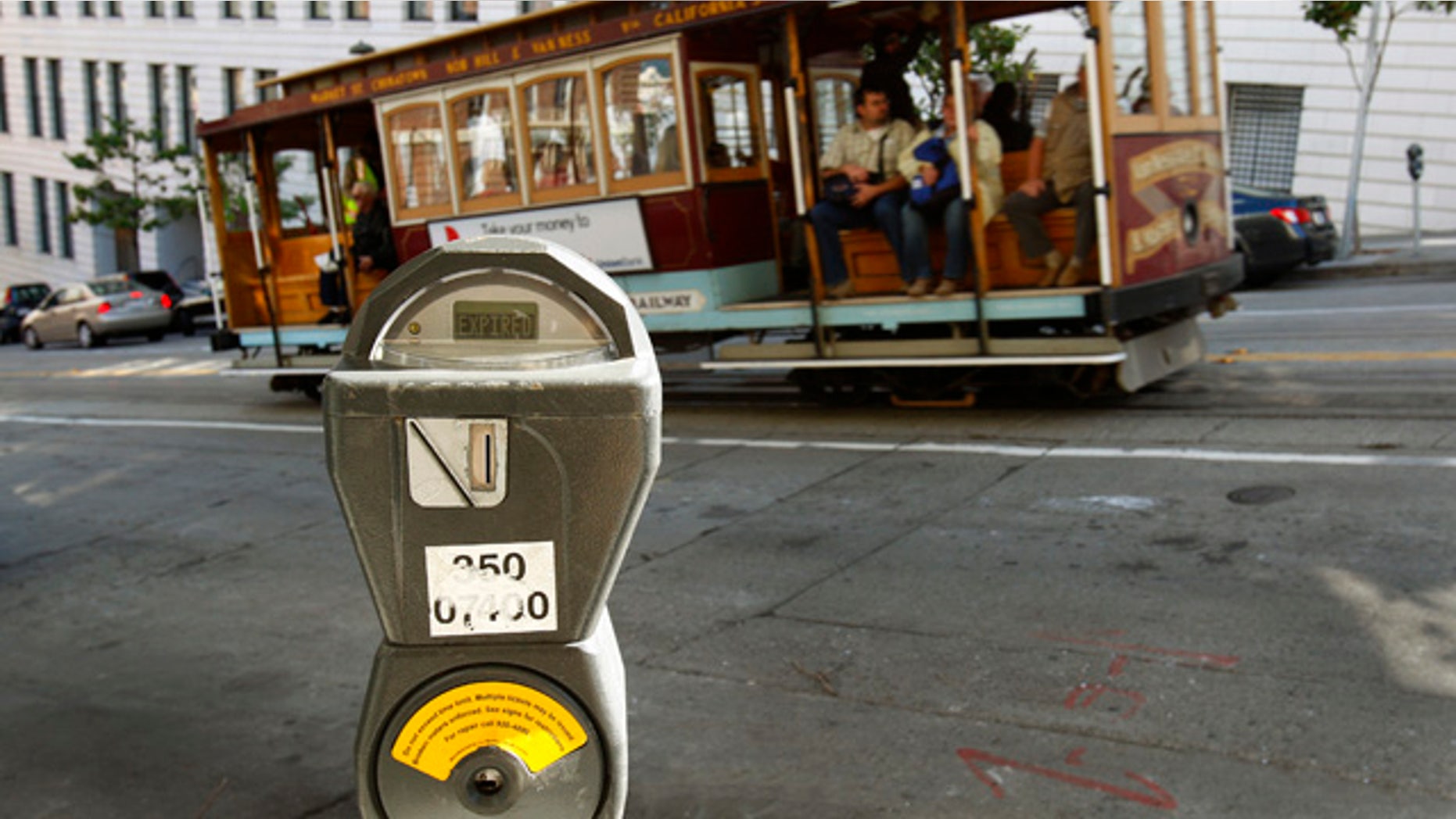 FILE - In this Oct. 27, 2009 file photo, a cable car passes a parking meter near San Francisco's financial district. (AP Photo/Ben Margot, File)