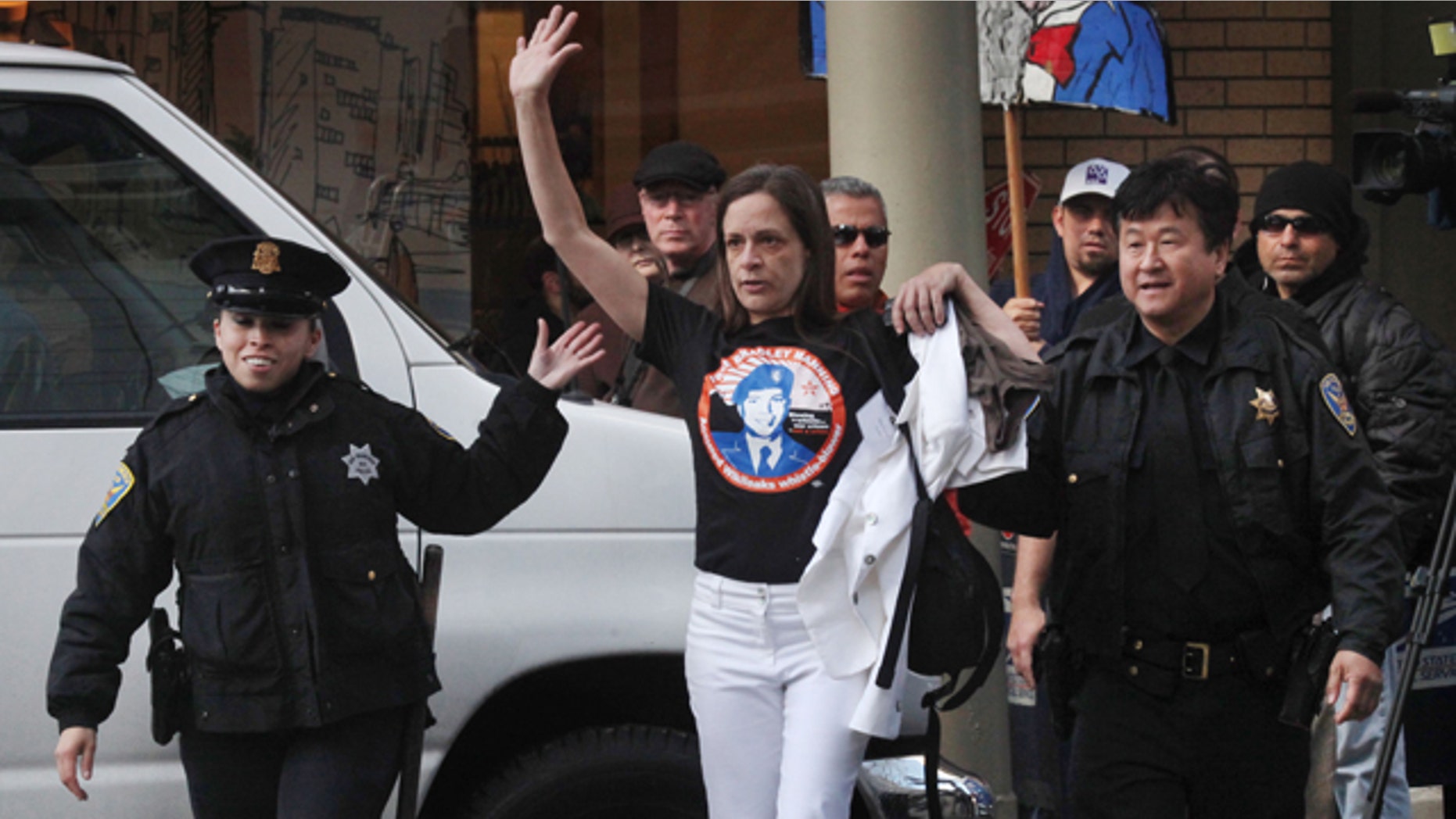 April 21: Naomi Pitcairn of Oakland is escorted by San Francisco Police Officers after protesting at a fundraiser fro President Barack Obama at the St. Regis in San Francisco, Calif.
