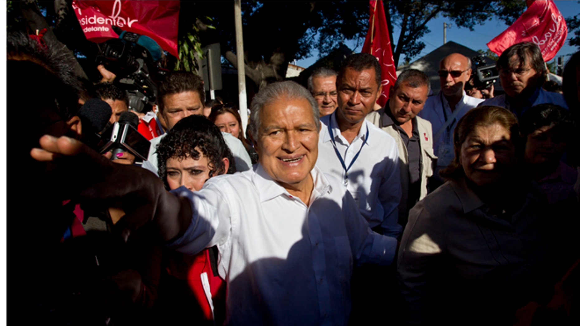 FILE - In this Feb. 2, 2014 file photo, Vice President Salvador Sánchez Cerén, presidential candidate for the ruling Farabundo Marti National Liberation Front (FMLN), greets supporters after voting at a polling station in San Salvador, El Salvador. Sanchez, a former guerrilla commander, is the favorite to win the second round presidential election Sunday, March 9, 2014. (AP Photo/Esteban Felix, File)