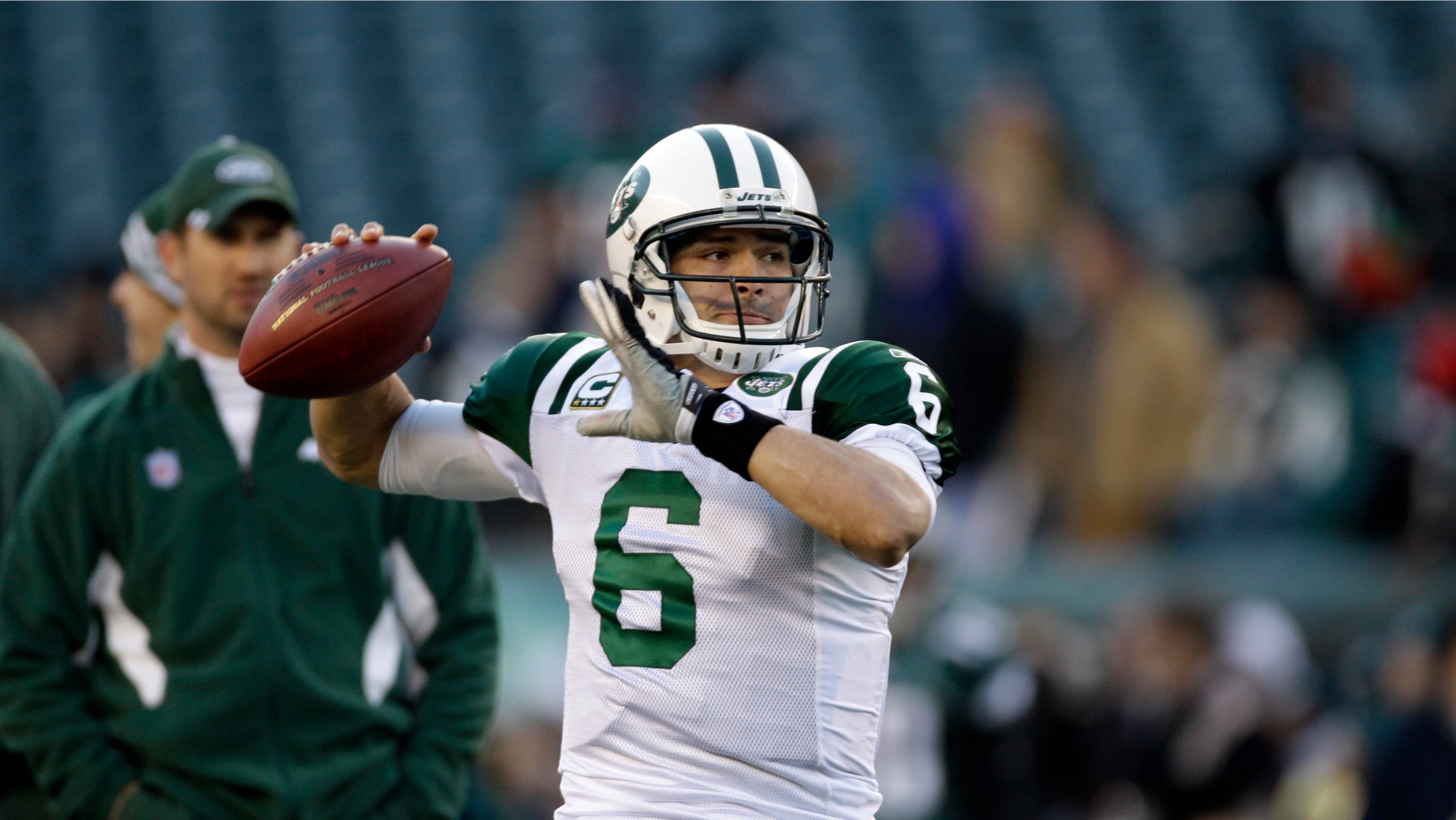 FILE - In this Dec. 18, 2011, file photo, New York Jets quarterback Mark Sanchez throws a pass before an NFL football game with the Philadelphia Eagles in Philadelphia. The Jets have extended quarterback Sanchez's contract and dropped out of pursuing free agent Peyton Manning. The team announced the extension for Sanchez in a conference call Friday night, March 9, 2012, and general manager Mike Tannenbaum says the Jets "looked at" going after Manning before deciding to stick with Sanchez. (AP Photo/Matt Slocum, File)