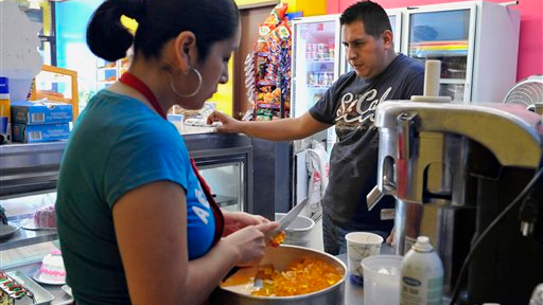 Dec. 16: In this file photo, immigrant Francisco Barranco stands in his bakery La Tapatia, as employee Lorena Vasquez prepares gelatin in the Fair Haven neighborhood in New Haven, Conn.