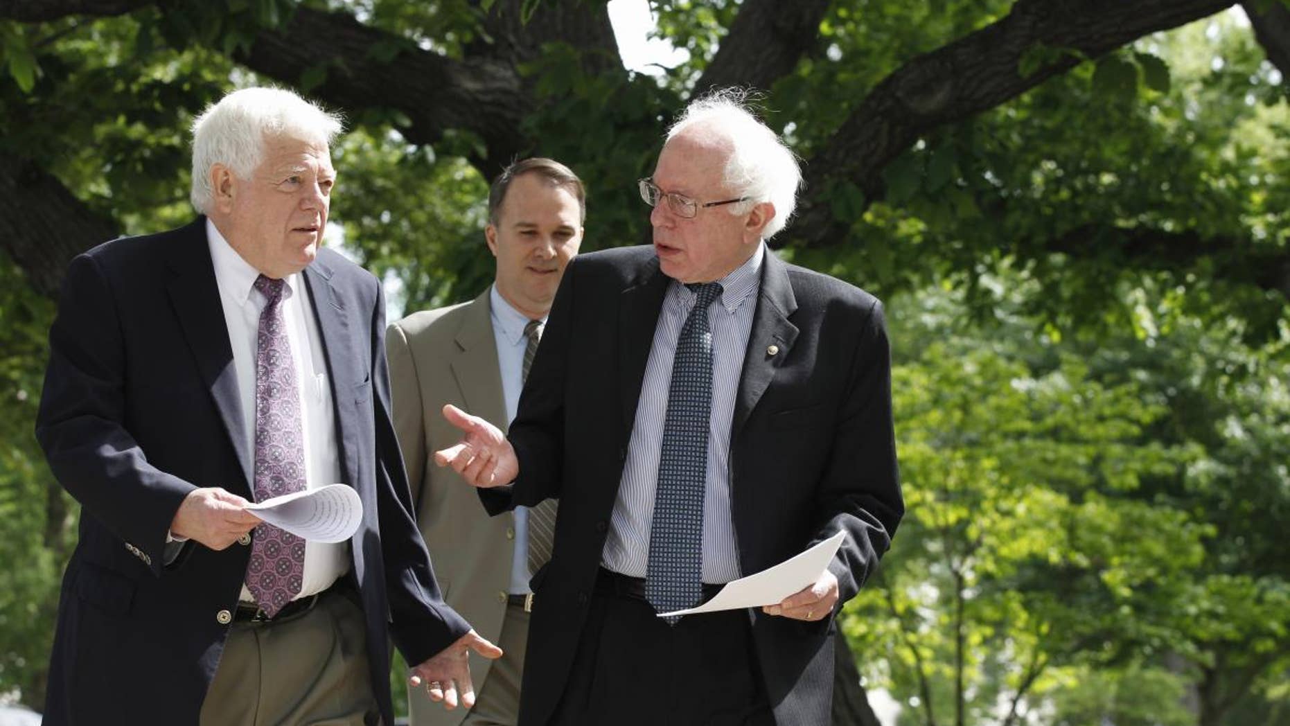 Sen. Bernie Sanders, I-Vt., right, talks with Rep. Jim McDermott, D-Wash., left, as they walk to news conference on Capitol Hill in Washington, Tuesday, May 10, 2011, to discuss their single-payer health care bills in the Senate and House. (AP Photo/Alex Brandon)