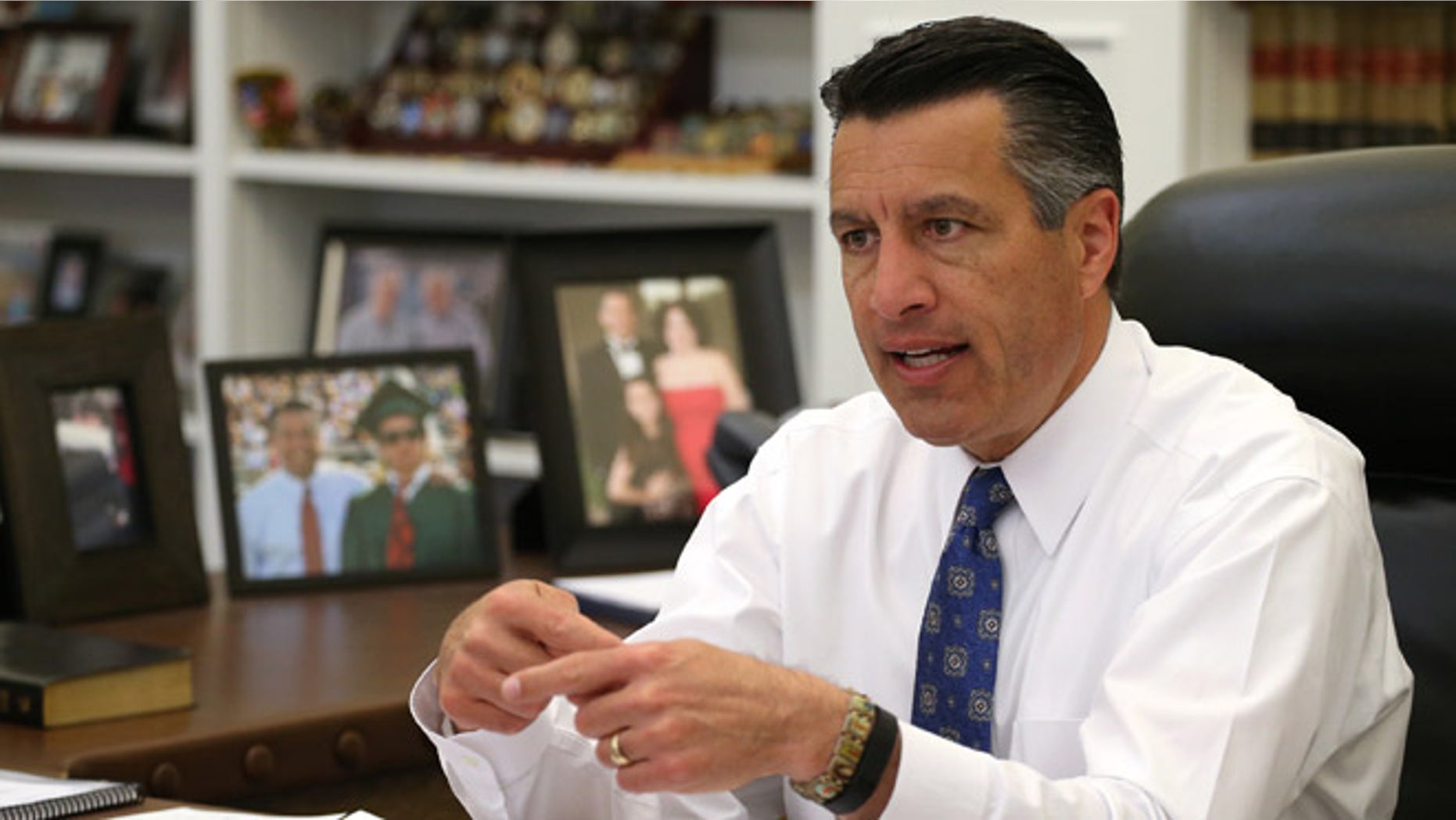 Nevada Gov. Brian Sandoval talks about the ongoing legislative session from his office at the Capitol in Carson City, Nev., on Friday, April 17, 2015. Sandoval says he's optimistic that lawmakers will reach a deal on the state's budget. (AP Photo/Cathleen Allison)