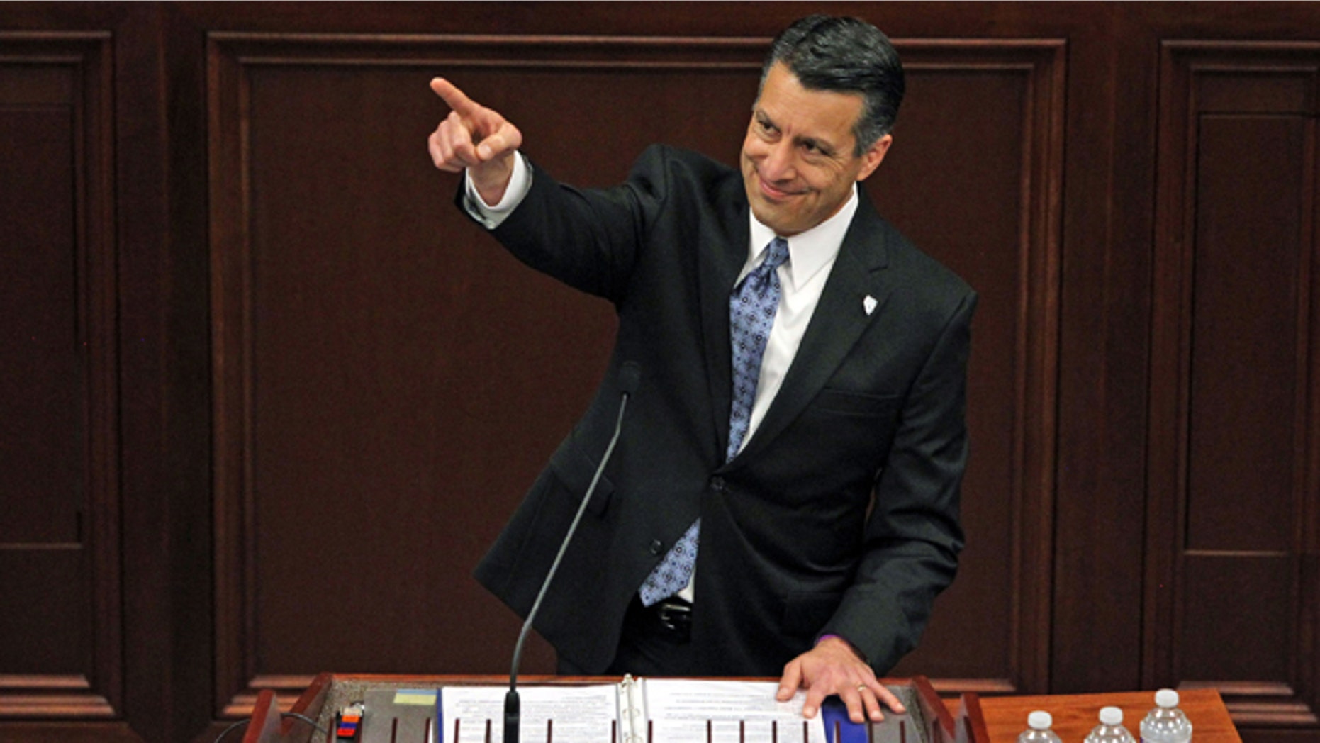 File - In a Thursday, Jan. 15, 2015 file photo, Nevada Gov. Brian Sandoval acknowledges a guest in the gallery during his State of the State address inside the Legislature building on the capital grounds in Carson City, Nev. Sandoval, who swept in to office with 71 percent of the vote, faces anger from other elected constitutional officers and several conservative Assembly members upset with his $7.3 billion, two-year budget that includes $1.1 billion in new and extended taxes. (AP Photo/Lance Iversen, File)
